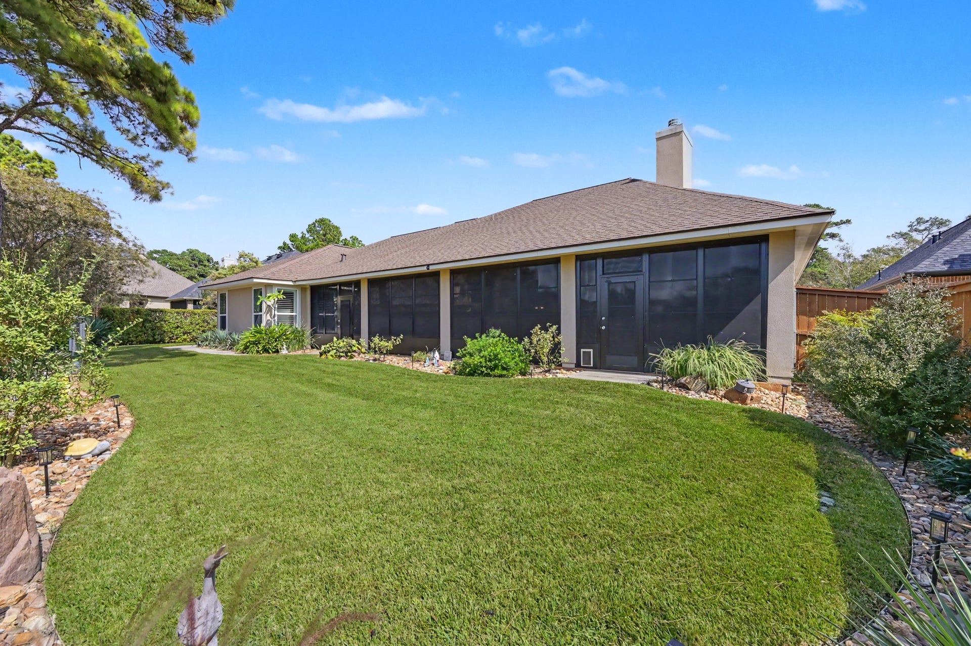 124 Wycliffe Drive, Montgomery, TX 77356 Expansive screened porch overlooking a peaceful, beautifully manicured backyard.