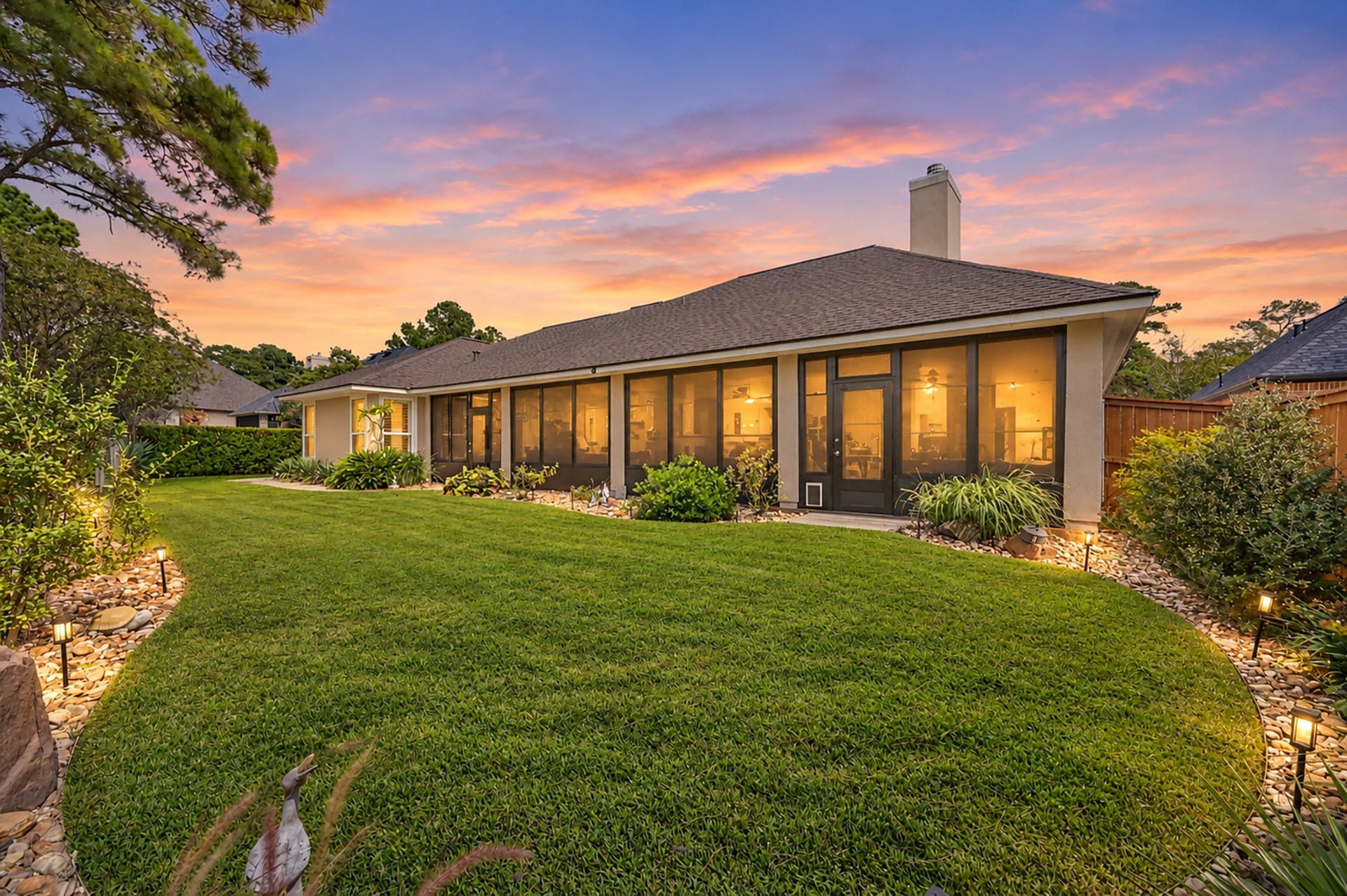 124 Wycliffe Drive, Montgomery, TX 77356 Gorgeous sunset highlights the expansive screened porch and beautifully landscaped backyard.