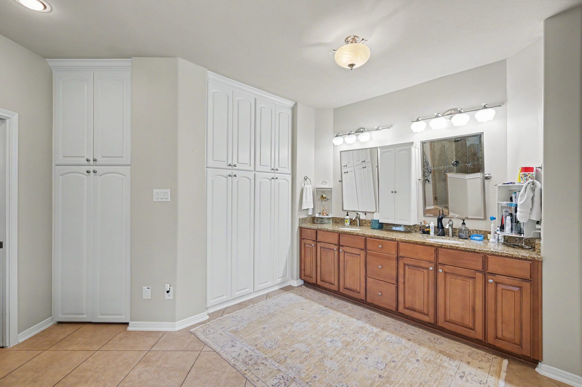 124 Wycliffe Drive, Montgomery, TX 77356 Spacious primary bathroom with dual vanities and extensive built-in storage.