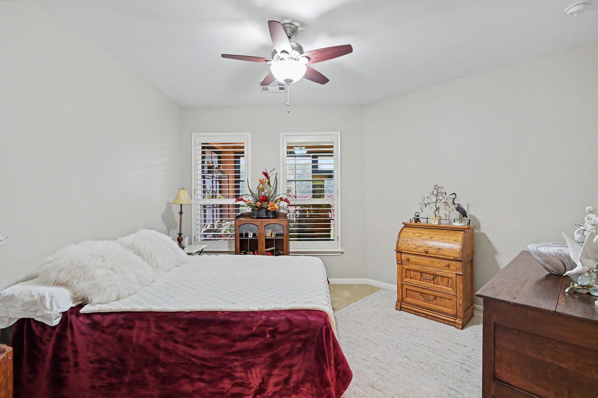 124 Wycliffe Drive, Montgomery, TX 77356 Comfortable guest bedroom with ceiling fan and attractive natural light.