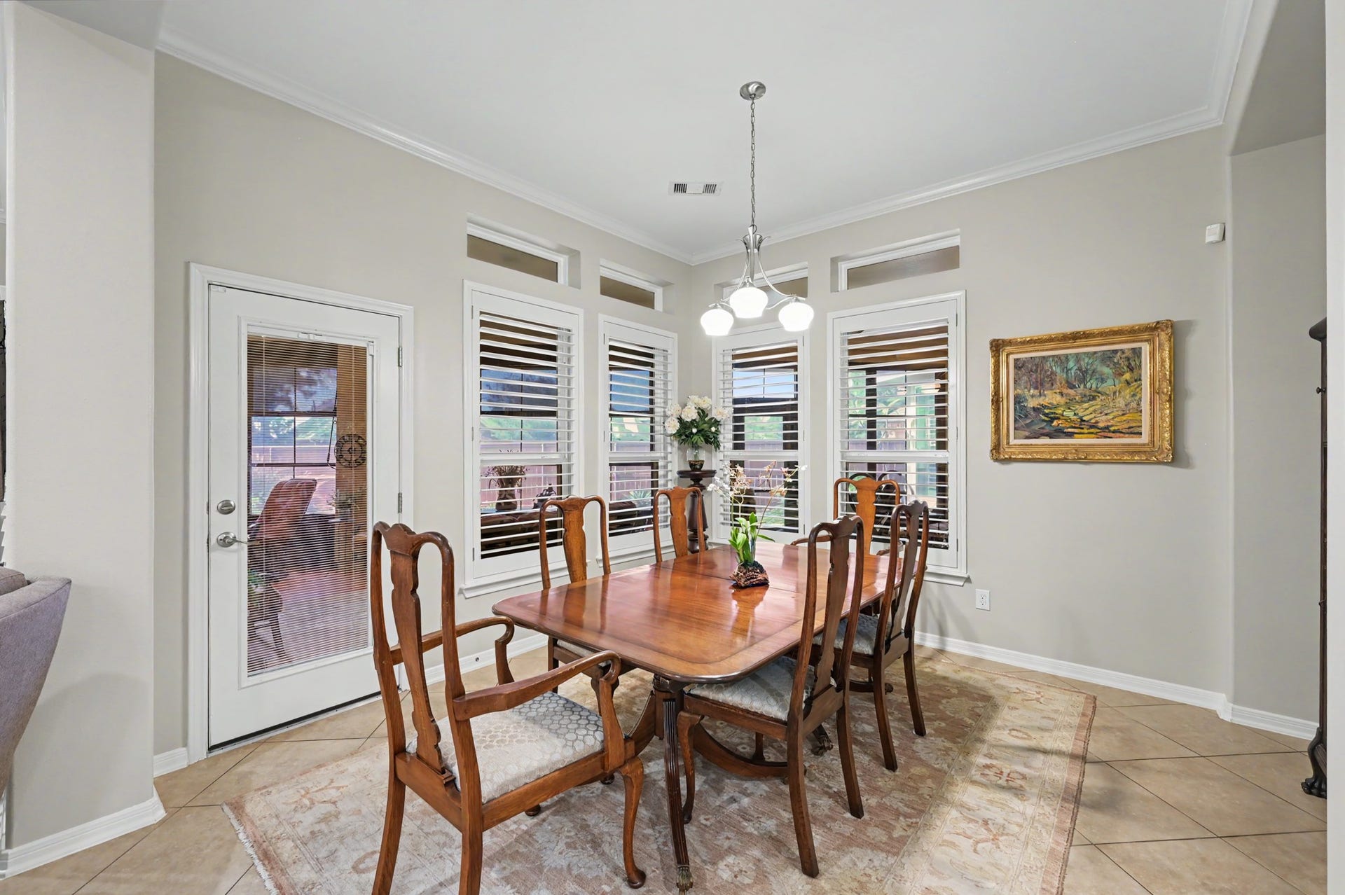 124 Wycliffe Drive, Montgomery, TX 77356 Elegant dining area with plantation shutters and lovely backyard views.