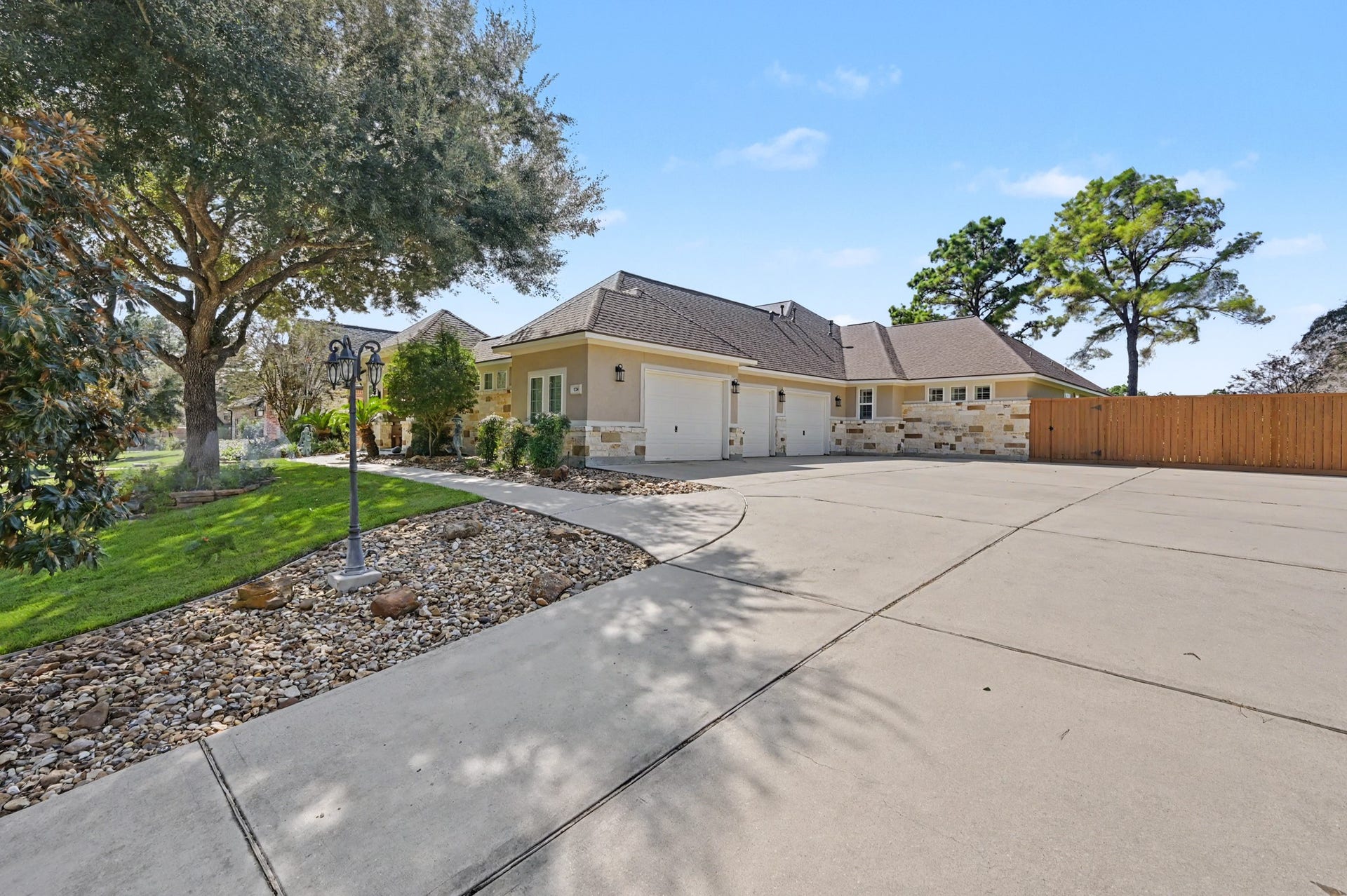 124 Wycliffe Drive, Montgomery, TX 77356 Impressive side-entry garage and generous driveway surrounded by mature trees.