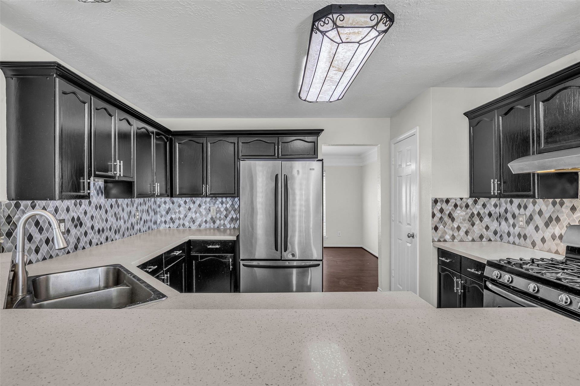 Ample counter space and a stainless double sink make meal prep and cleanup easy.