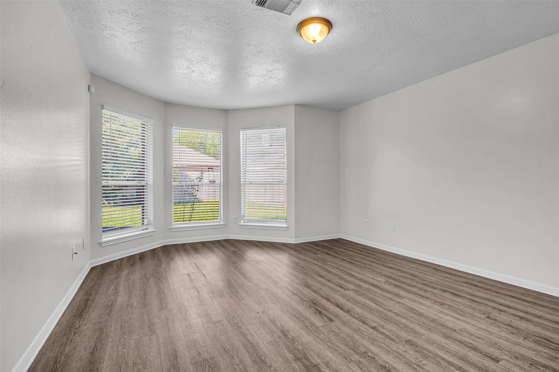 Unwind in the primary bedroom on the first floor, with a bay window sitting area.