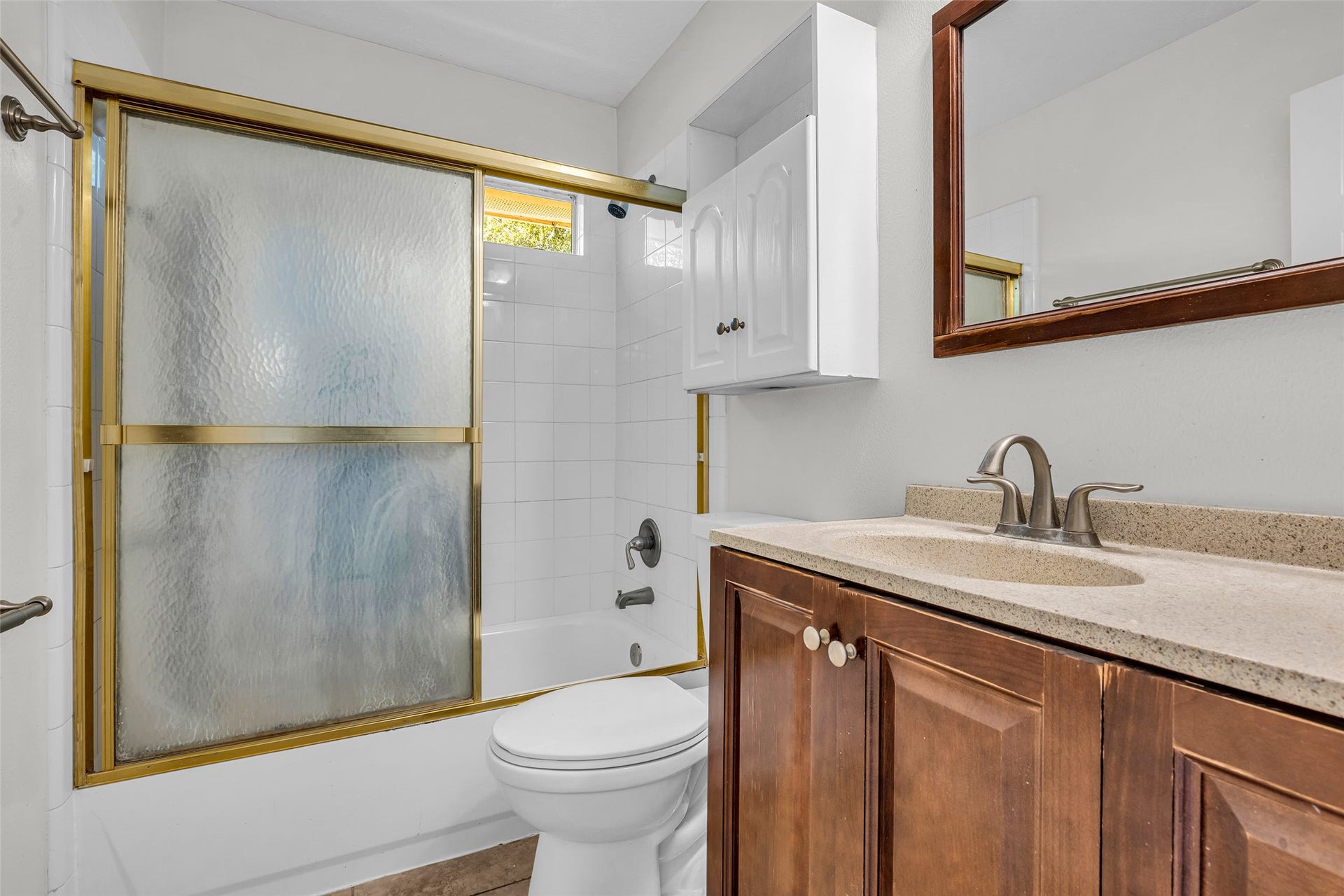 A full bath with a tub/shower combo and plenty of storage.