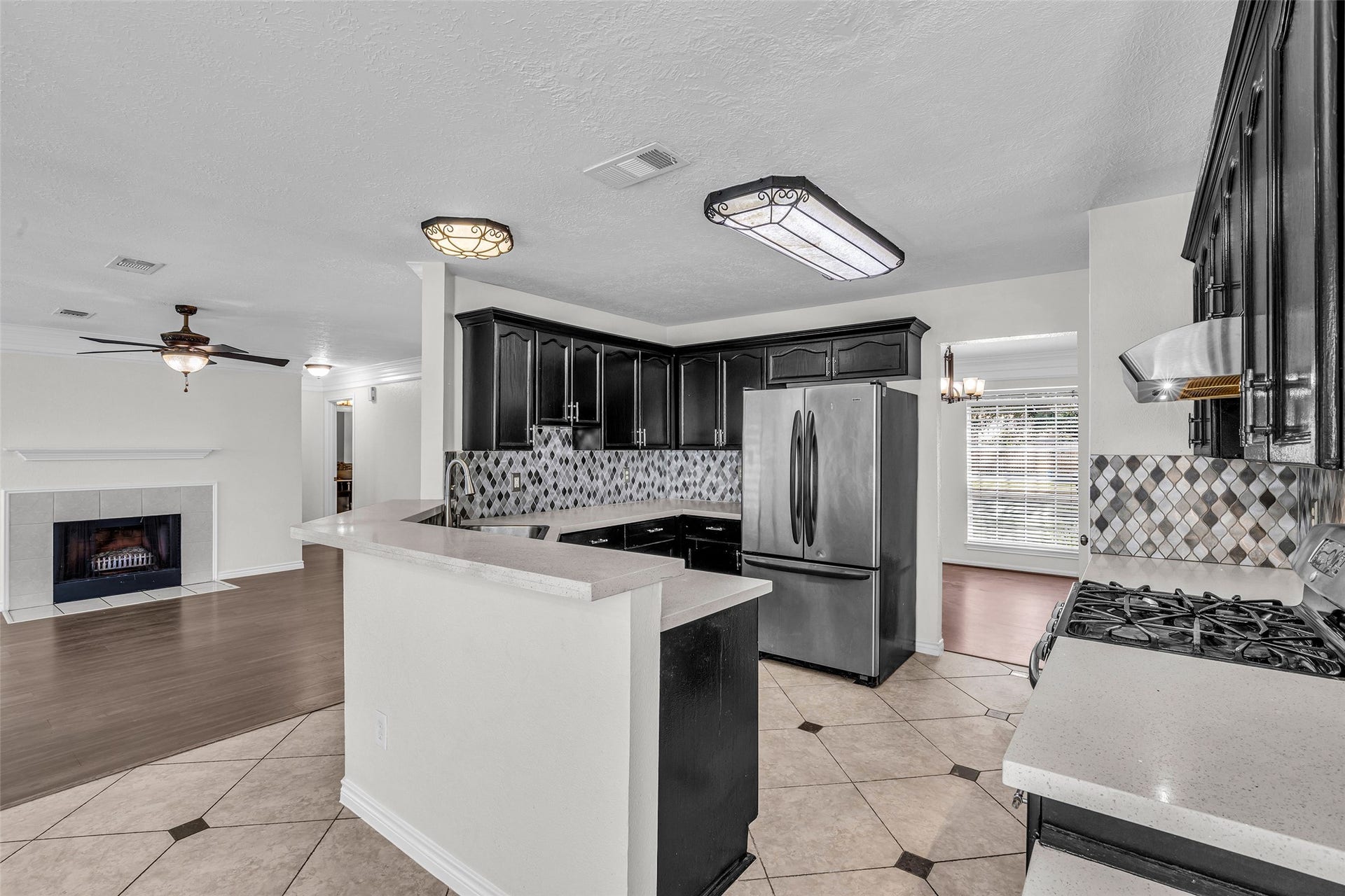 Chat with guests in the living room while you cook, with the kitchen open to the fireplace.
