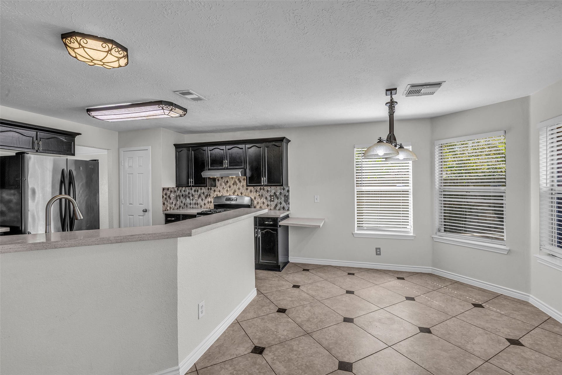 Start the morning in the sunny breakfast nook, framed by windows.