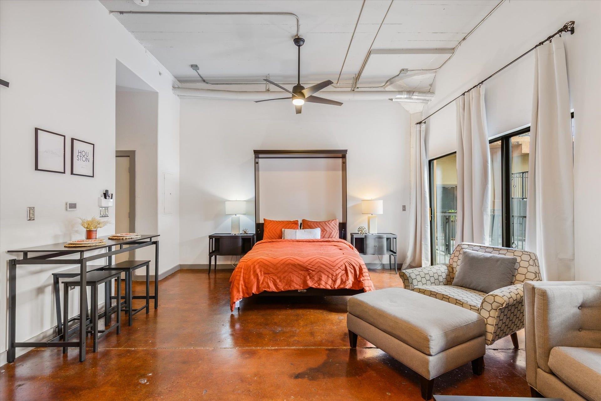 2205 Mckinney Street, #309, Houston, TX 77003 The 14' ceilings throughout this loft living space give a spacious yet cozy atmosphere.
