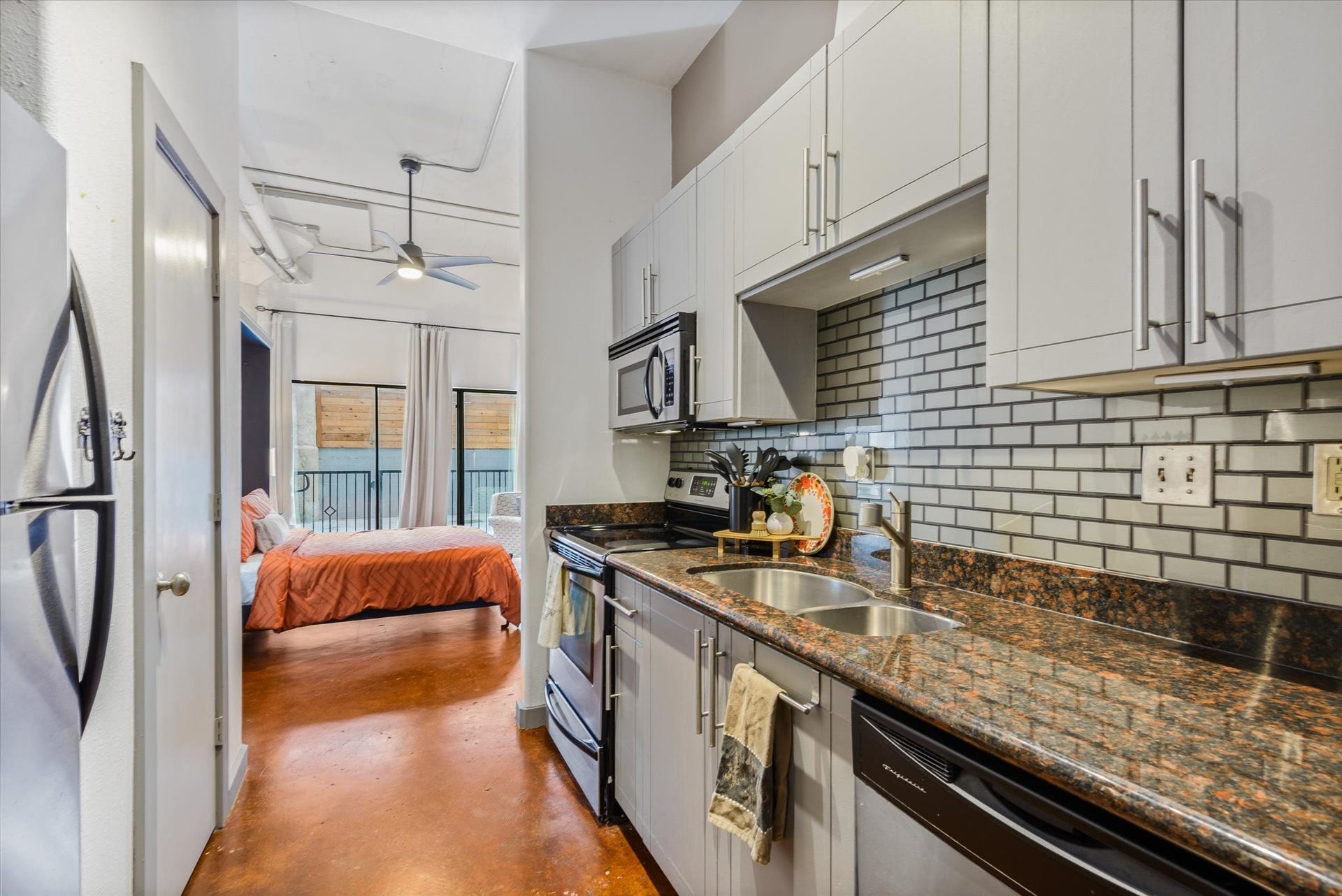 2205 Mckinney Street, #309, Houston, TX 77003 Recently painted kitchen cabinets and recently installed glass backsplash.