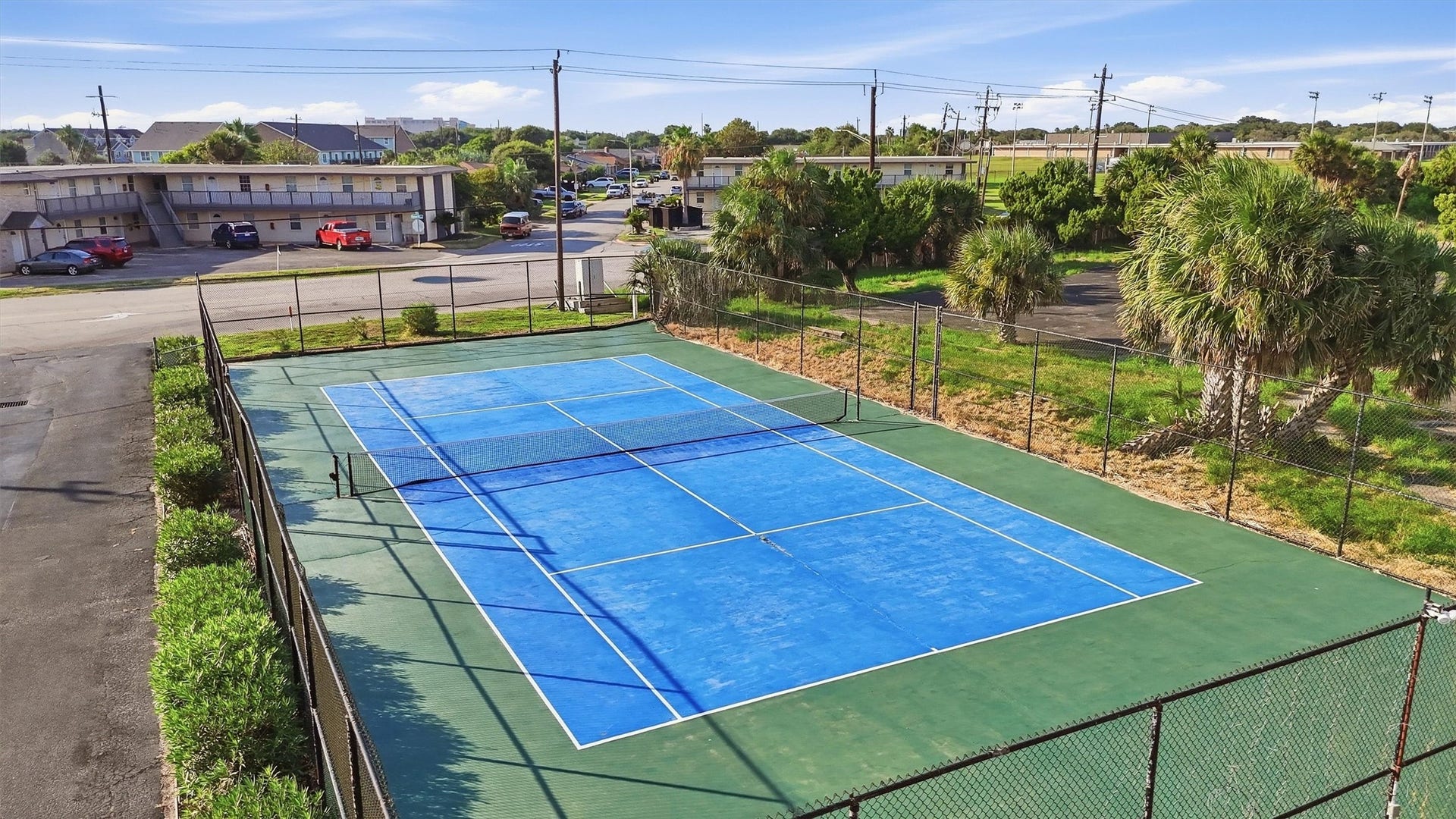 7310 Seawall Boulevard, #1105, Galveston, TX 77551 Enjoy access to a well-maintained tennis court, perfect for active living in a community setting.