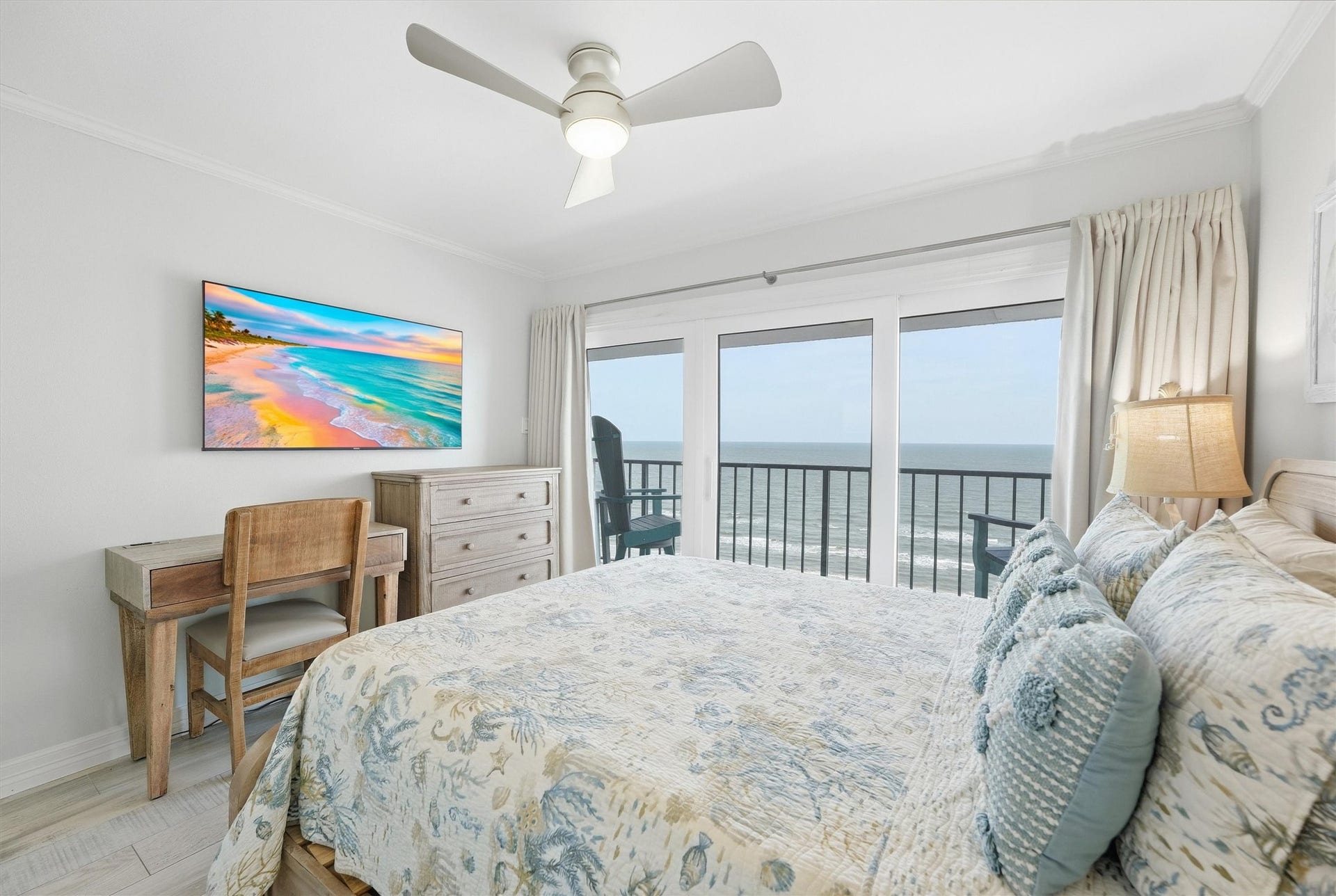 7310 Seawall Boulevard, #1105, Galveston, TX 77551 Bright and airy bedroom with ocean views, featuring a cozy bed, stylish decor, and a private balcony for seaside relaxation.