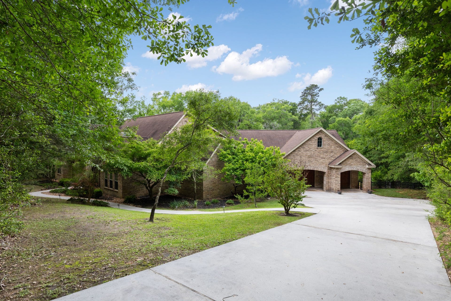7421 Enchanted Stream Drive, Conroe, TX 77304 Three car oversized garage plus additional covered parking and massive amounts of extra parking on the property!
