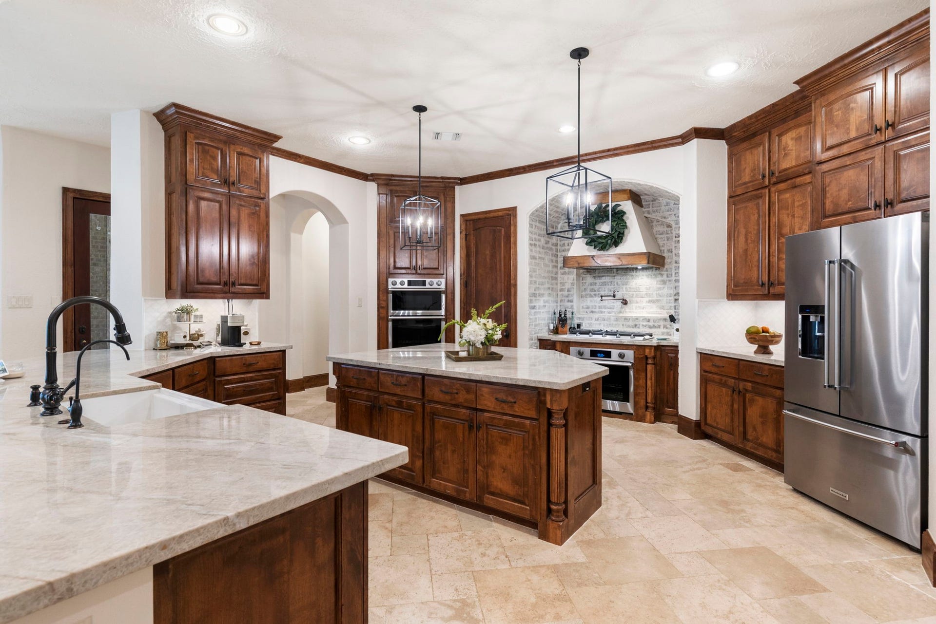 7421 Enchanted Stream Drive, Conroe, TX 77304 Stunning island kitchen with recent SS appliances, Taj Mahal quartzite countertops, gas cooktop and double ovens.