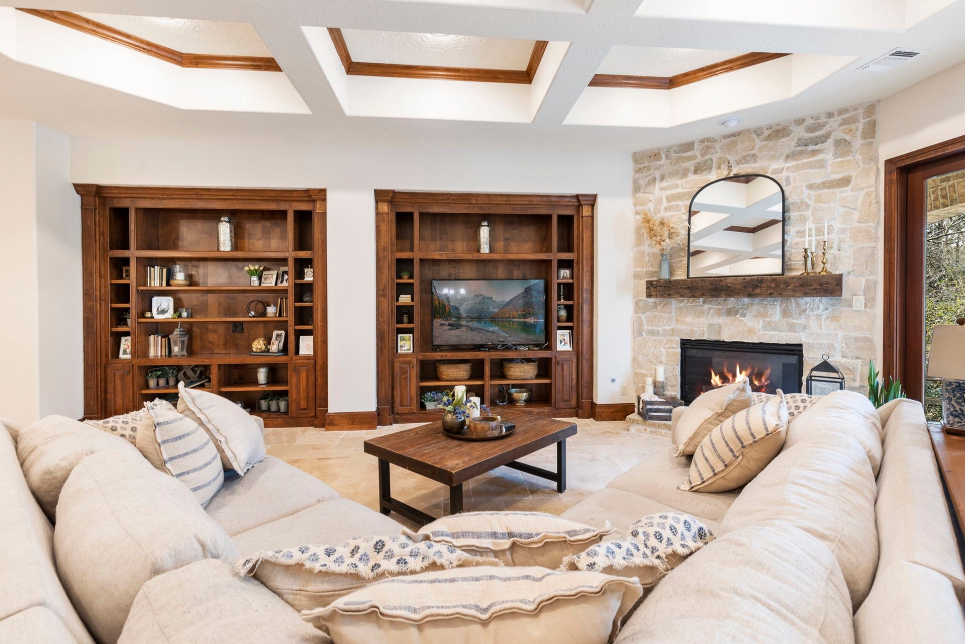 7421 Enchanted Stream Drive, Conroe, TX 77304 So many architectural upgrades in this home including the coffered ceilings with wood accents and upgraded fireplace with a reclaimed mantel from a church in Virginia.