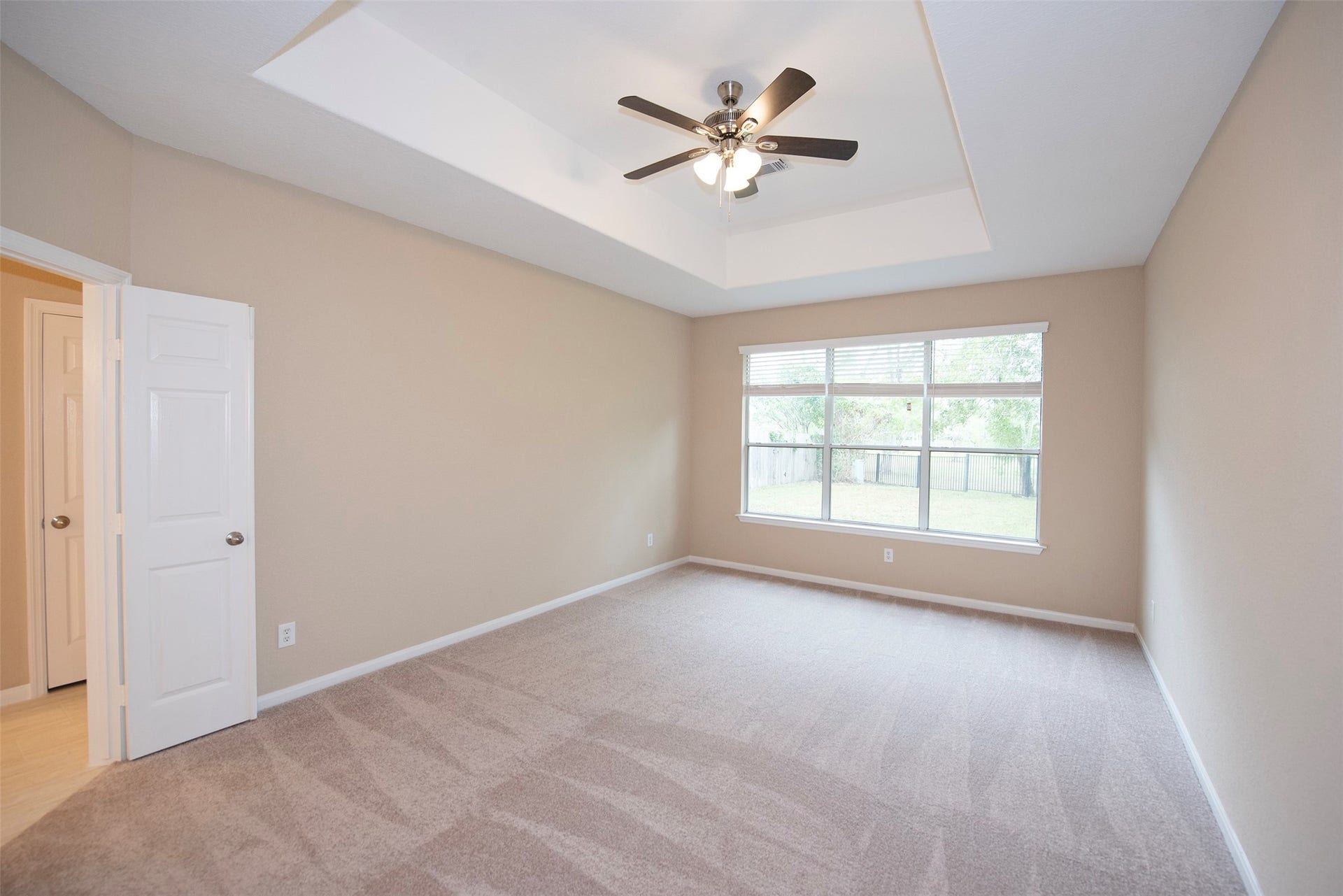 10411 Village Lake Drive, Missouri City, TX 77459 Primary bedroom located on the first floor with tray ceiling and plenty of room for your king sized furniture.