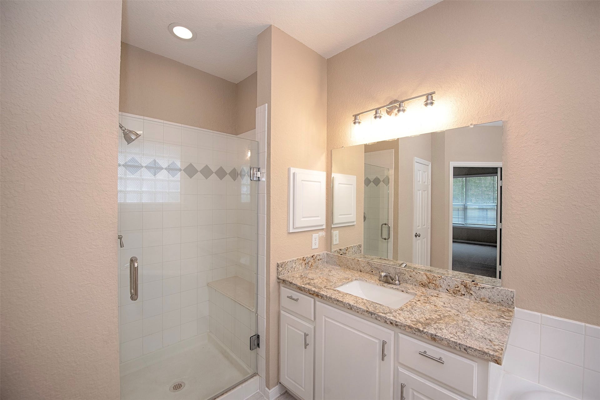 10411 Village Lake Drive, Missouri City, TX 77459 Secondary sink and access to the large walk in shower which even has seating.