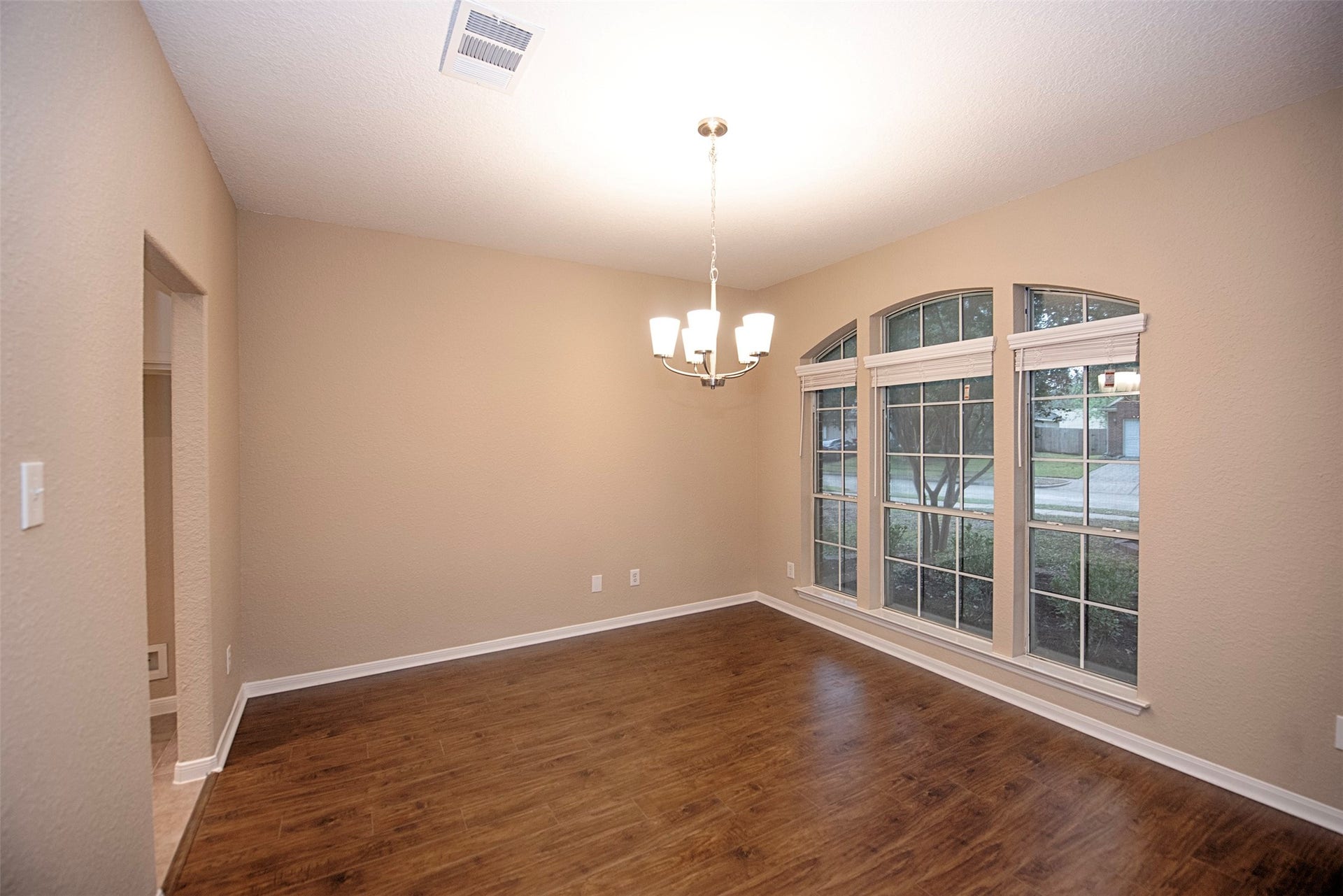 10411 Village Lake Drive, Missouri City, TX 77459 Formal dining room with waterproof laminate floors and plenty of space for your large dining table and space for a china cabinet or buffet.