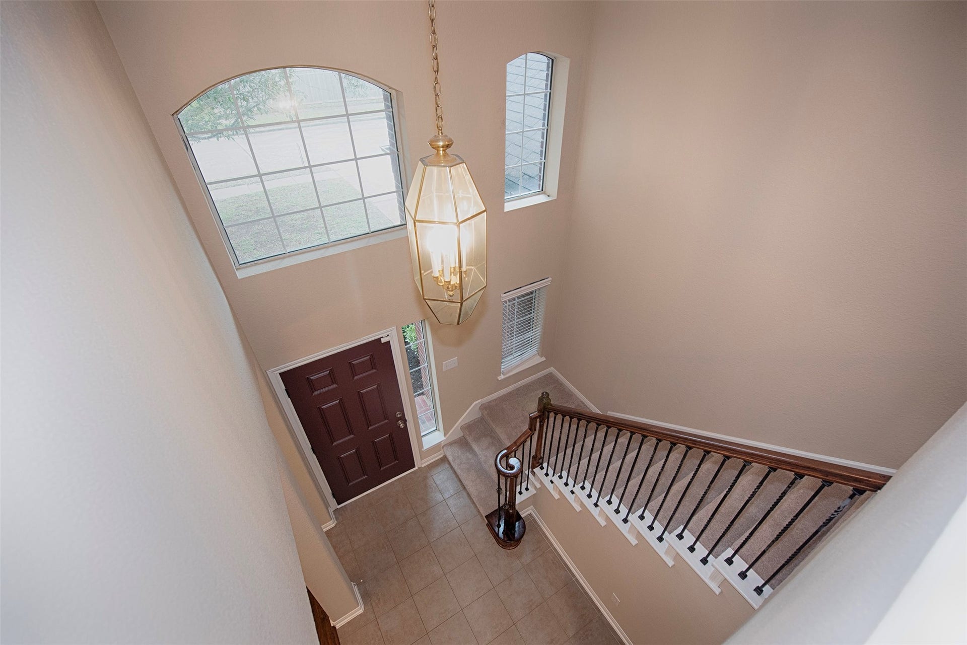 10411 Village Lake Drive, Missouri City, TX 77459 at the top of the stairs a view of the gorgeous foyer with the soaring ceiling.