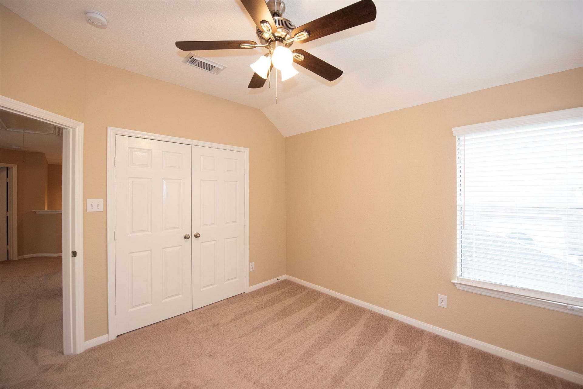 10411 Village Lake Drive, Missouri City, TX 77459 A view of the room with vaulted ceiling and double door closet.