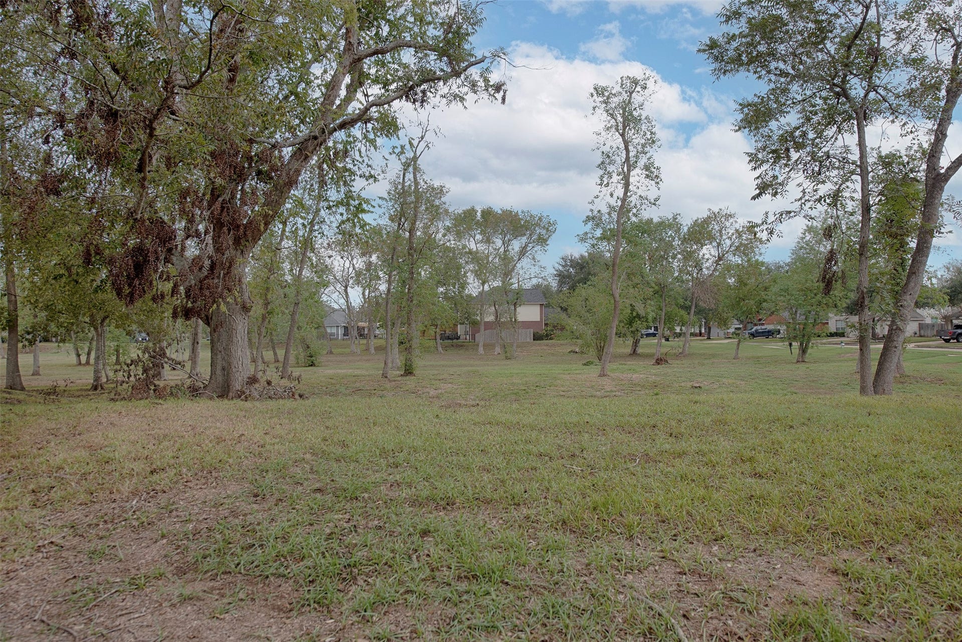 10411 Village Lake Drive, Missouri City, TX 77459 A view of the tremendous HOA owned green area located next to your new home. No side neighbors and great area for the kids to play or to walk the family dog in the evening.