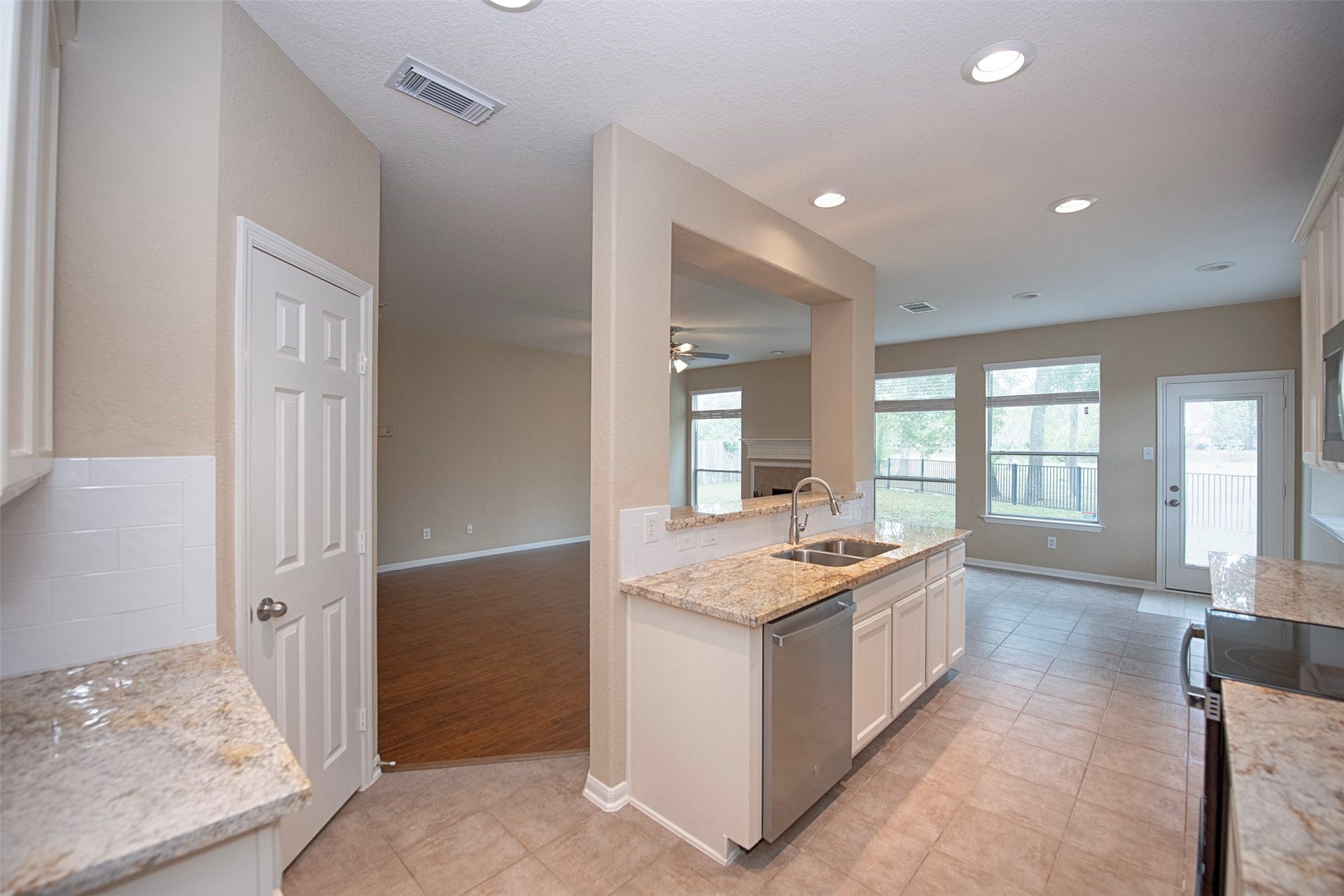 10411 Village Lake Drive, Missouri City, TX 77459 Entry to the gourmet kitchen from the dining room. Amazing space, granite counters and stainless appliances.