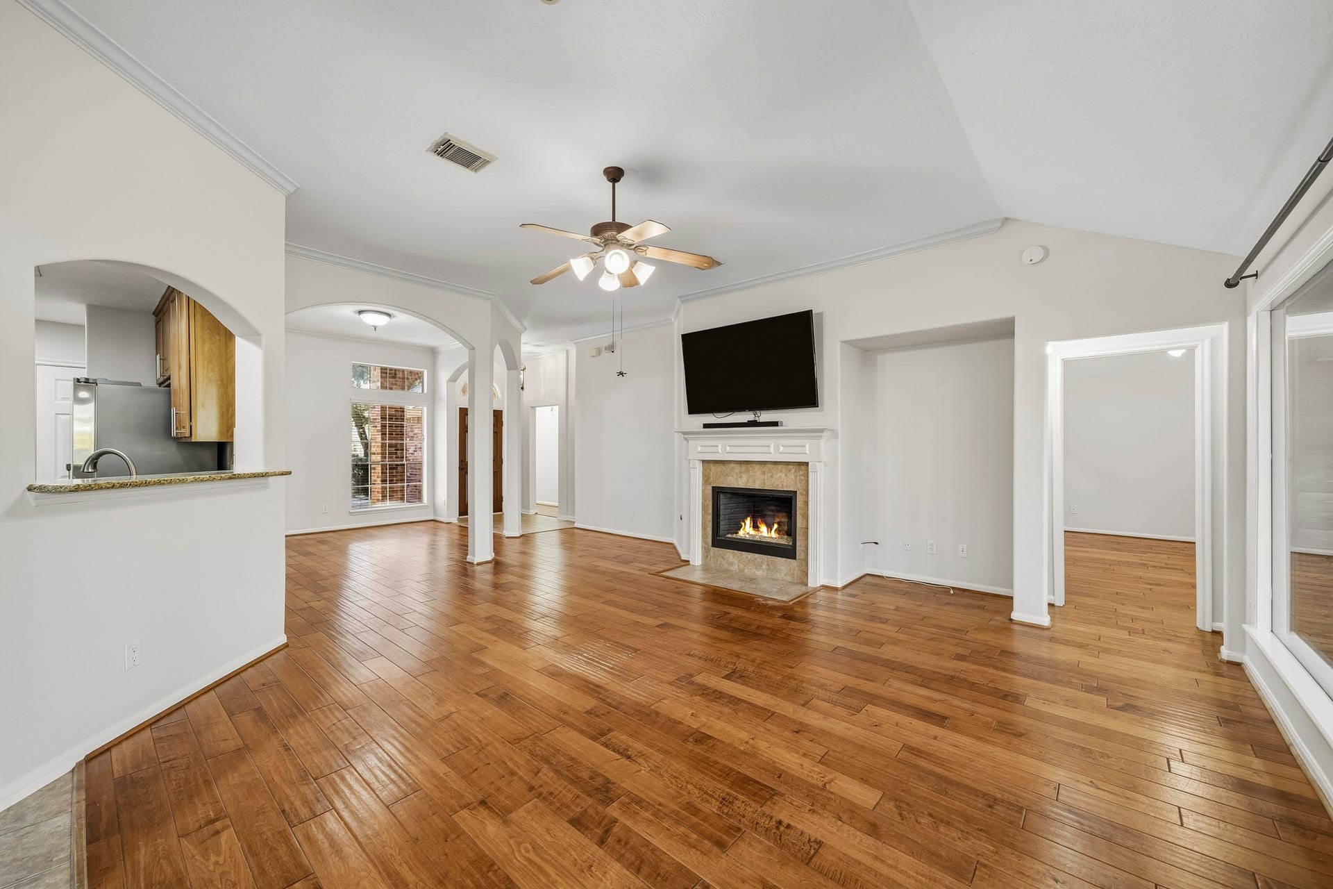 Cozy fireplace with an alcove for furnishings are among the architectural features of this great family room. This inviting space serves as the heart of the home, offering both warmth and character.