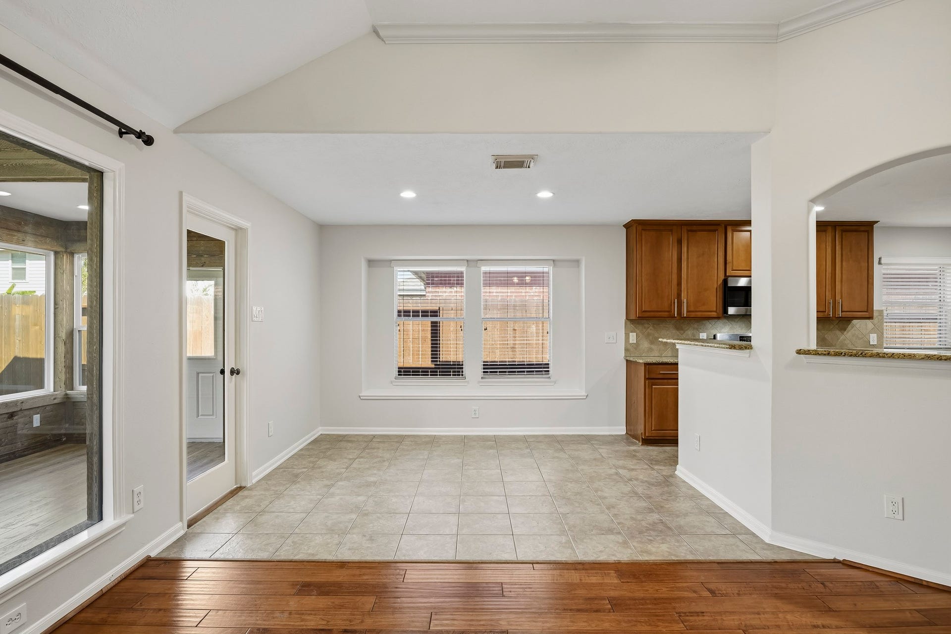 Breakfast area featuring an abundance of natural light, durable tile flooring, and a seamless open-concept design that flows into the kitchen and living spaces.