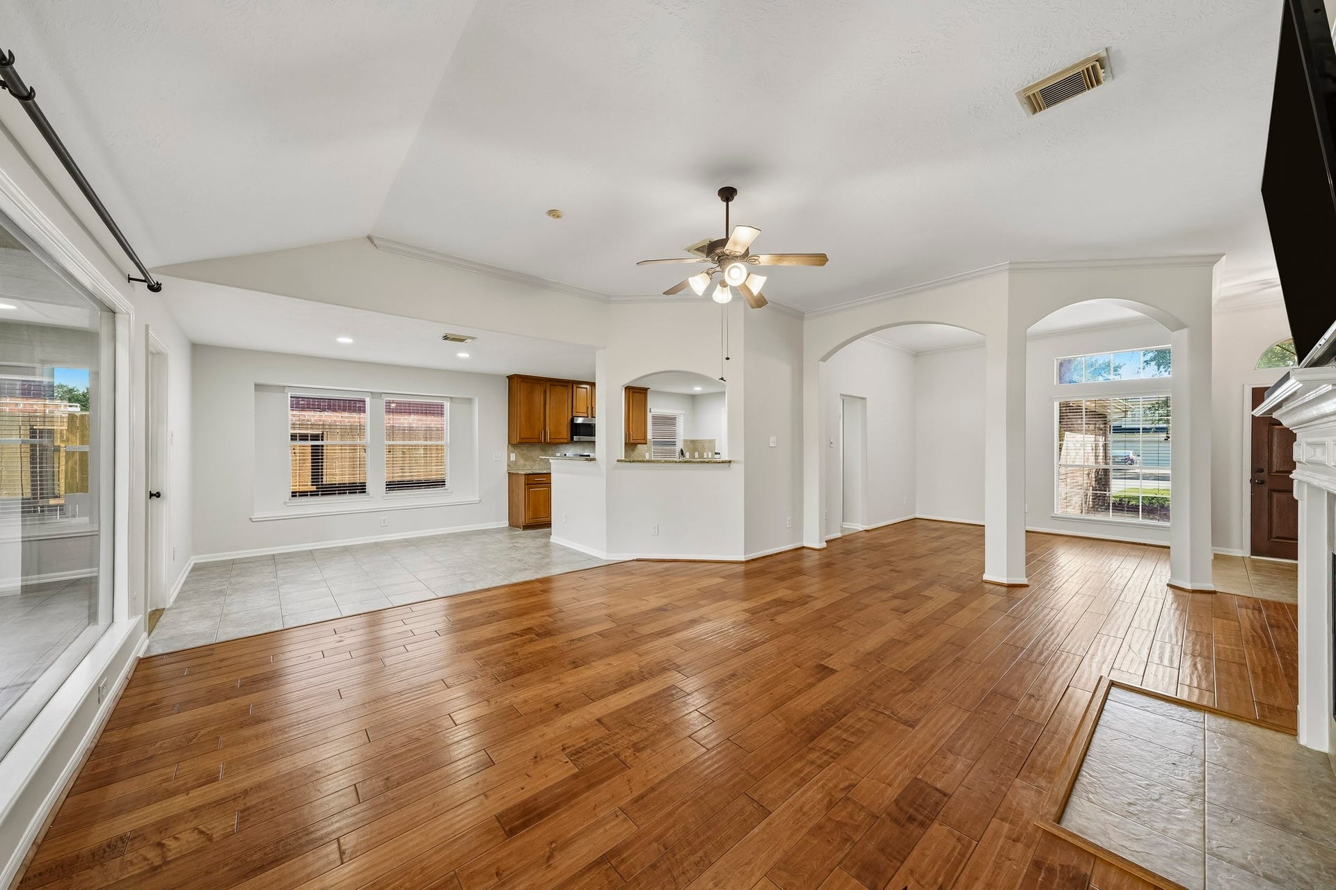 Expansive family room featuring raised ceilings and an open-concept layout that seamlessly flows into the dining area, creating an atmosphere of sophisticated grandeur