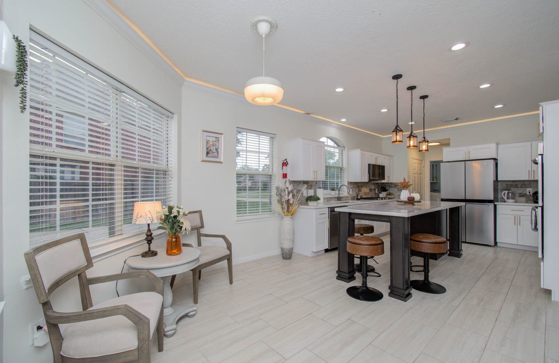 15627 Twisting Springs Drive, Cypress, TX 77433 Bright and inviting kitchen with modern finishes, featuring a large island with seating, stainless steel appliances, and ample natural light from multiple windows.