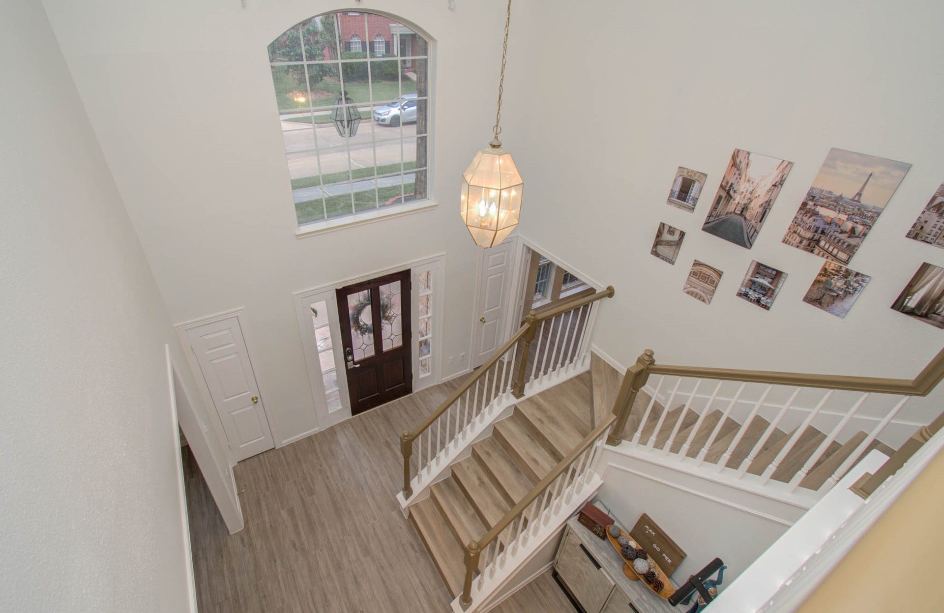 15627 Twisting Springs Drive, Cypress, TX 77433 Bright and welcoming foyer featuring a grand staircase, elegant chandelier, and large window for abundant natural light.