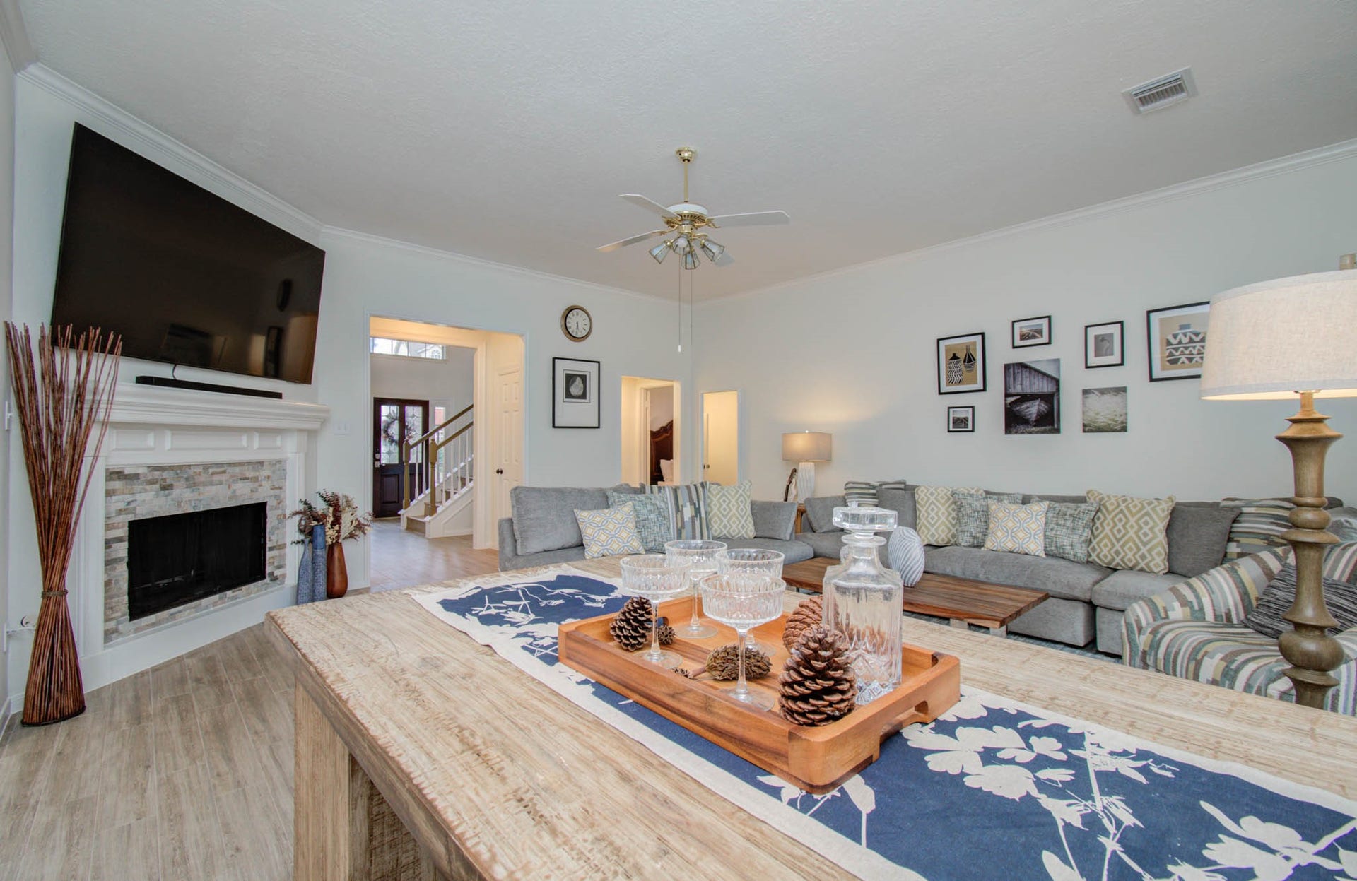 15627 Twisting Springs Drive, Cypress, TX 77433 Spacious living room with a cozy fireplace, elegant decor, and a comfortable sectional sofa, perfect for relaxing or entertaining.