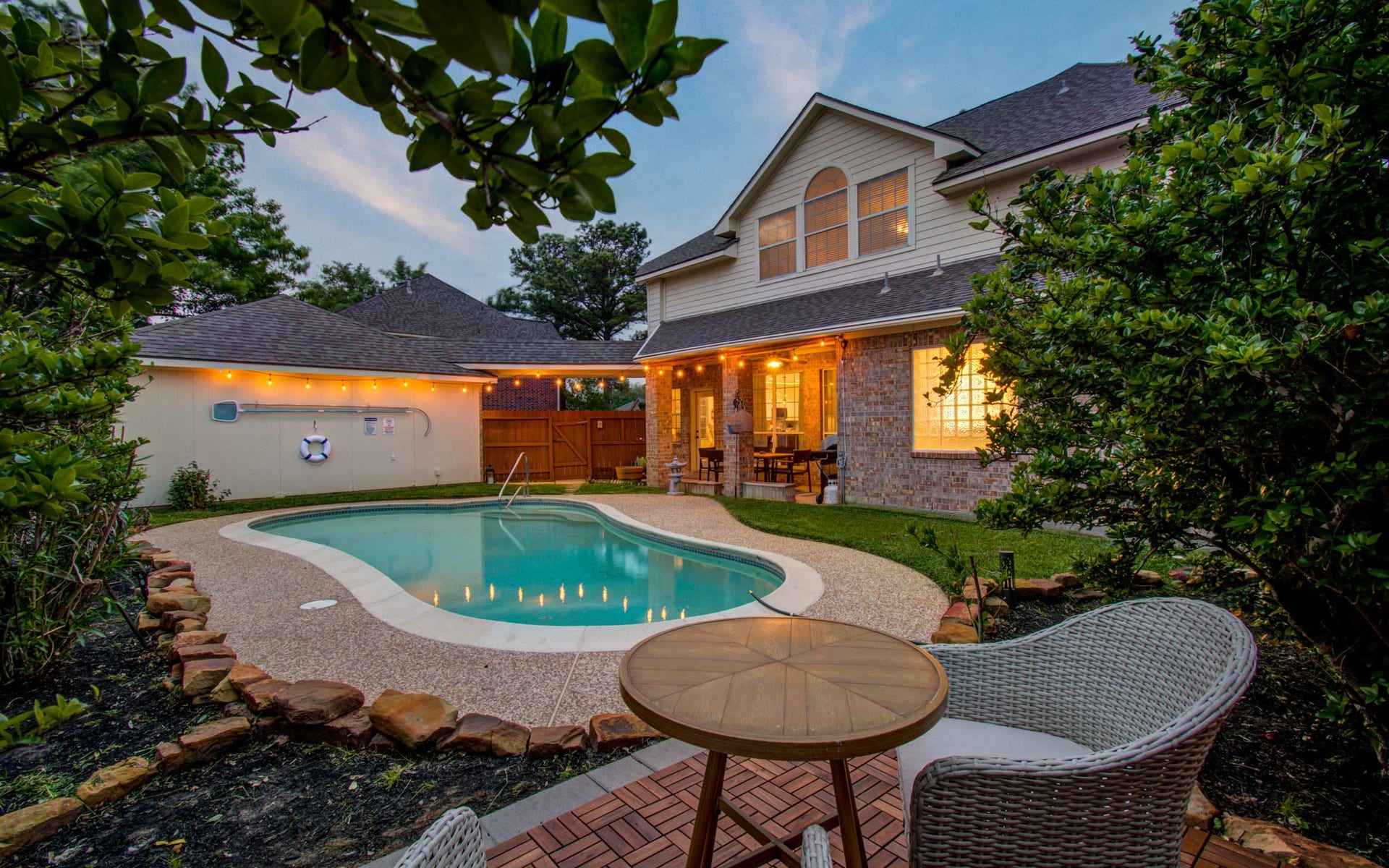 15627 Twisting Springs Drive, Cypress, TX 77433 Charming backyard oasis featuring a sparkling pool, cozy patio area, and lush landscaping, perfect for relaxing evenings and entertaining guests.