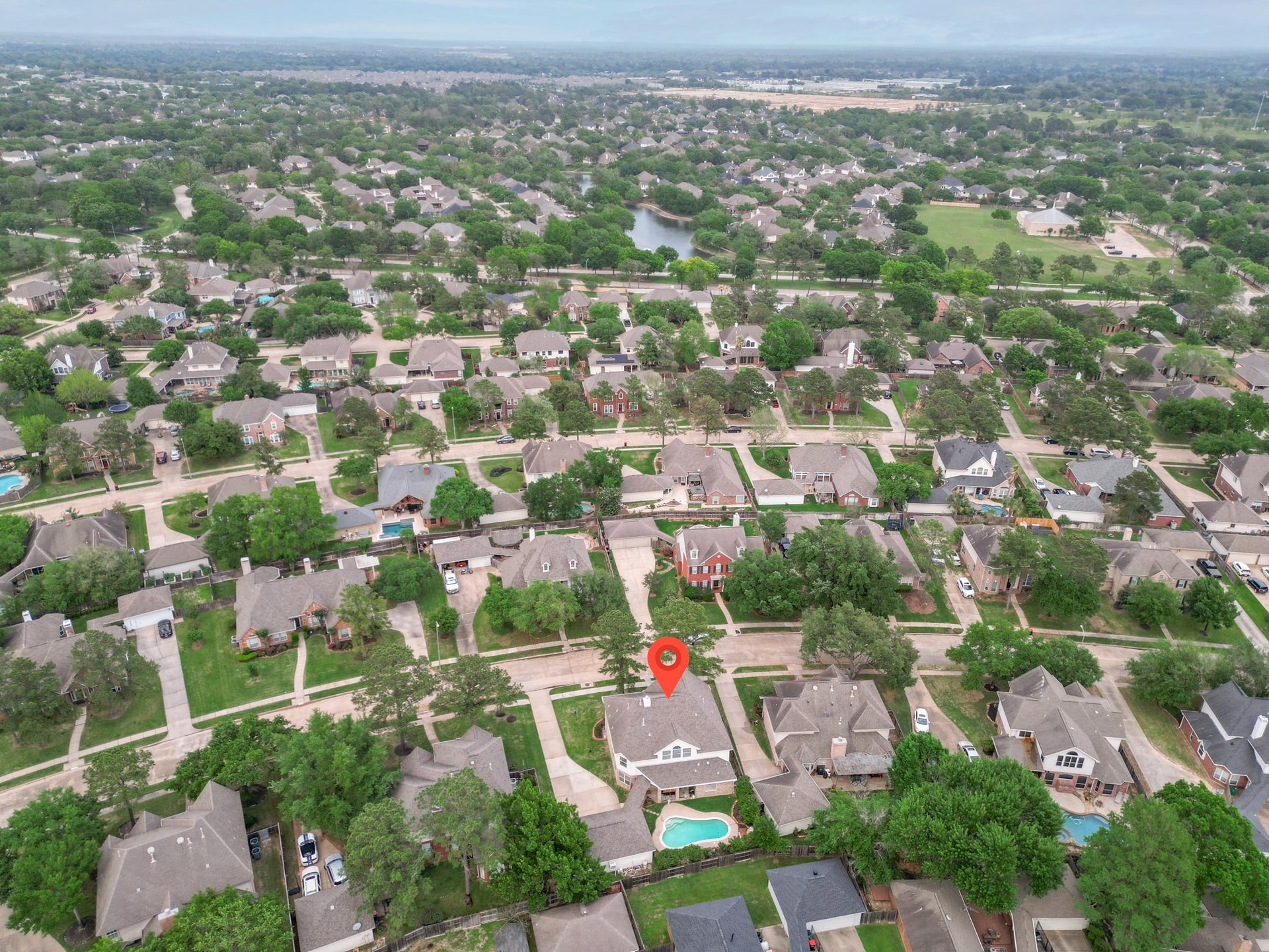 15627 Twisting Springs Drive, Cypress, TX 77433 Nestled in a lush, tree-lined neighborhood, this charming home offers a spacious backyard with a pool, perfect for relaxation and entertaining. Its prime location provides easy access to nearby amenities and scenic views.