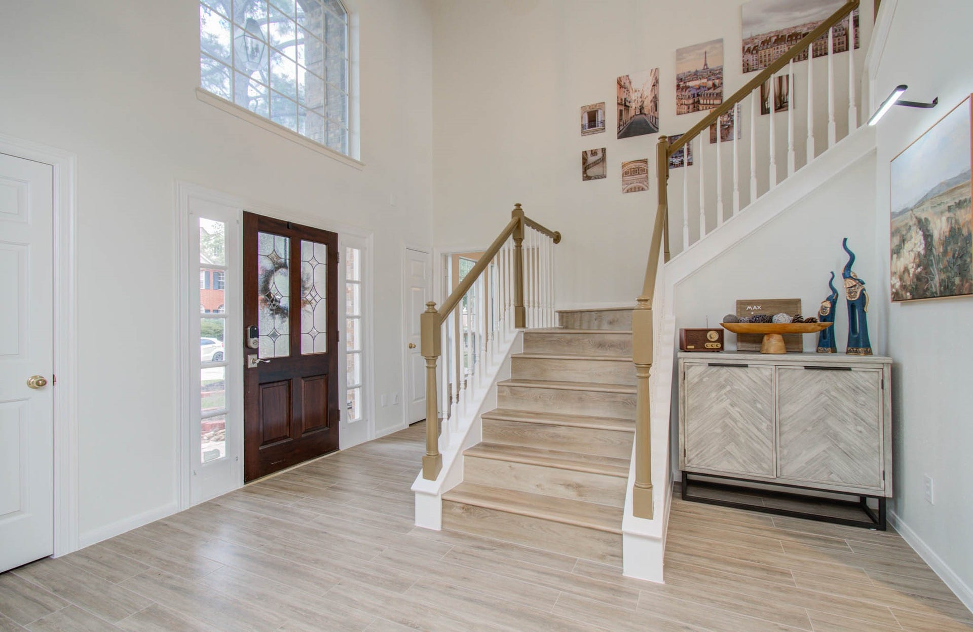 15627 Twisting Springs Drive, Cypress, TX 77433 Bright and welcoming entryway with high ceilings, elegant staircase, and abundant natural light, creating a spacious and inviting atmosphere.