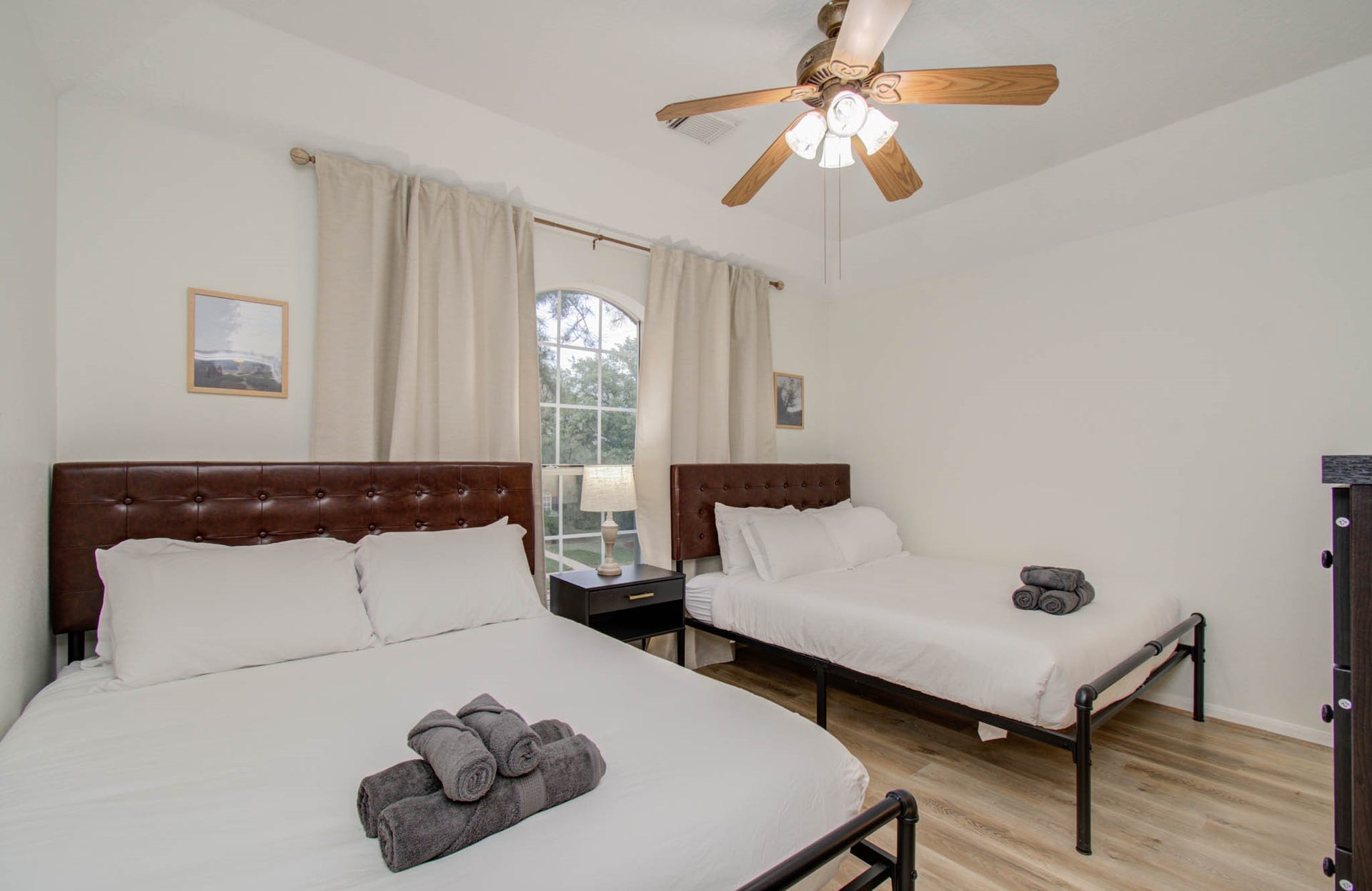 15627 Twisting Springs Drive, Cypress, TX 77433 Bright and inviting bedroom with two comfortable beds, a ceiling fan, and a large window that brings in natural light.