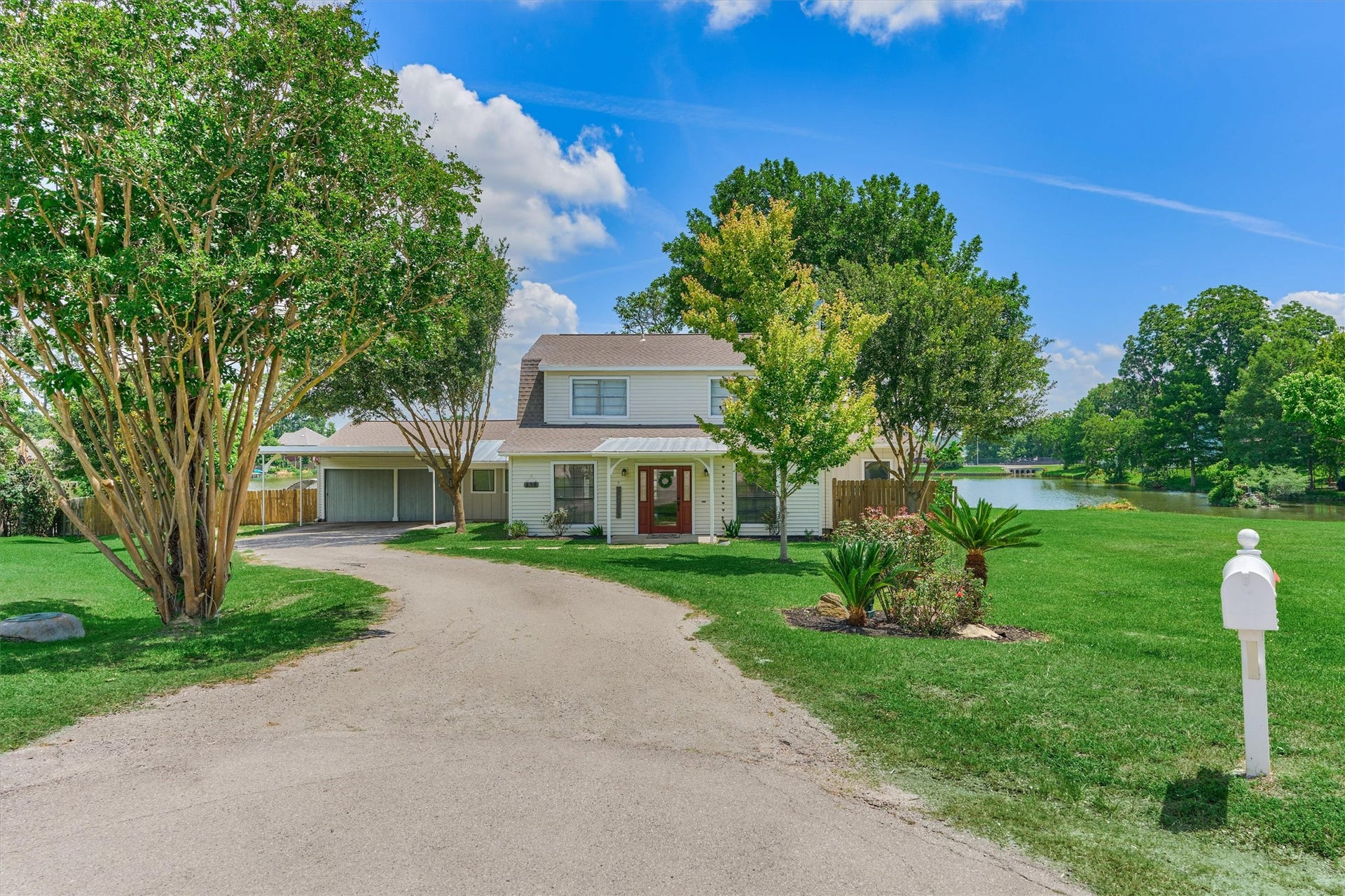 438 Lazy Lane, Montgomery, TX 77356 Welcome to your private waterfront retreat, perfectly positioned along a scenic community lake with breathtaking views stretching toward Lake Conroe.