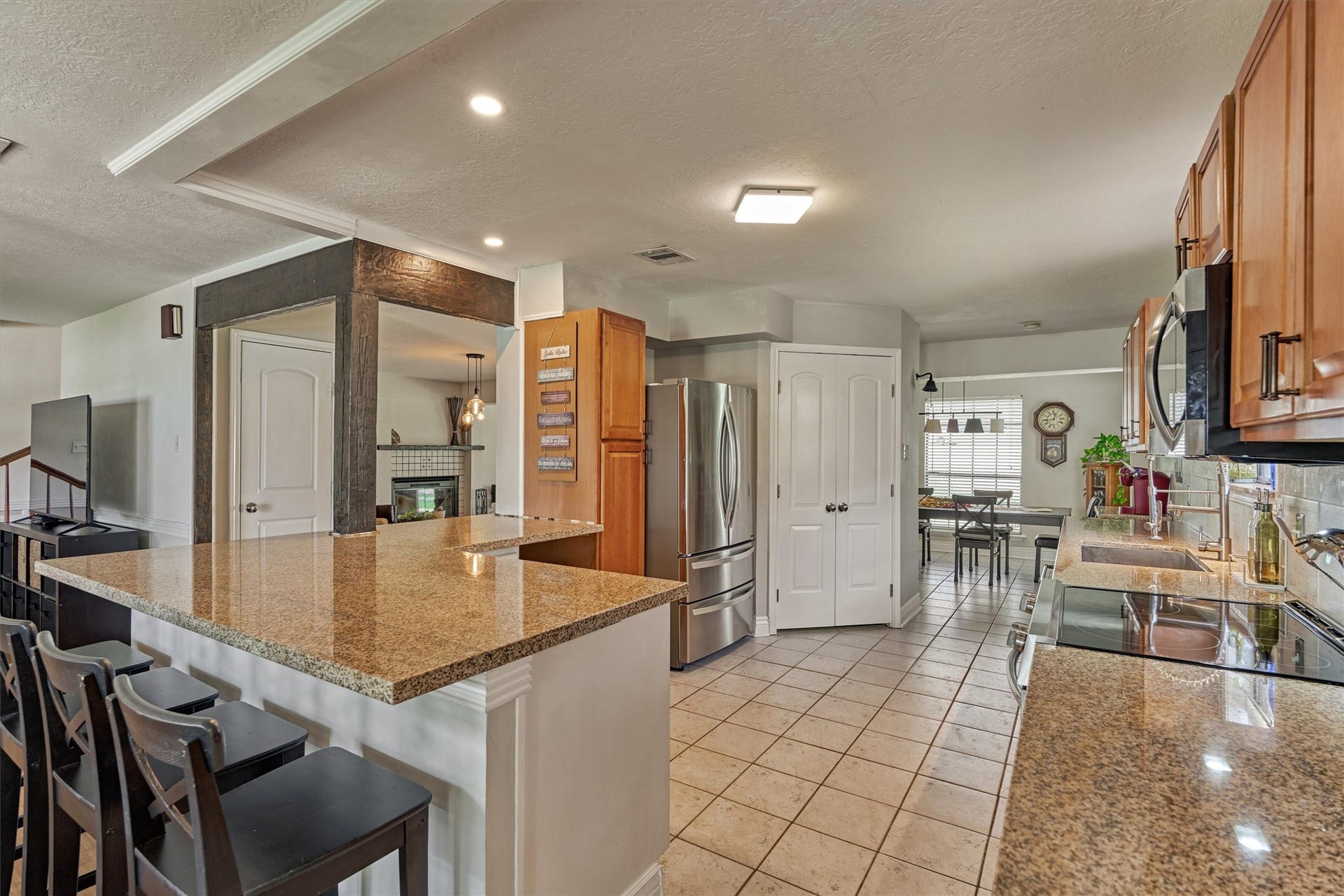 438 Lazy Lane, Montgomery, TX 77356 Generous granite counter space surrounds this well-appointed kitchen, offering plenty of room for meal prep, serving and gathering.