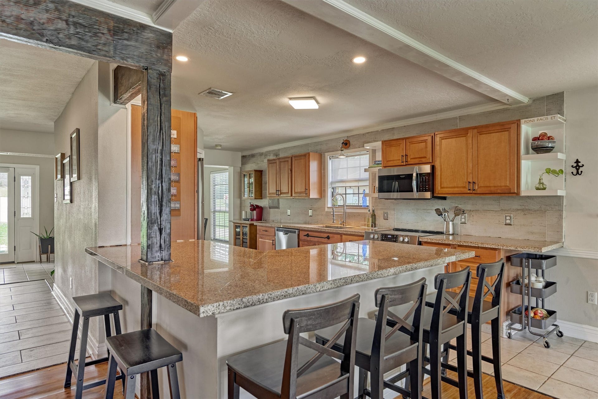 438 Lazy Lane, Montgomery, TX 77356 Thoughtfully updated kitchen showcases granite countertops, upgraded appliances, updated fixtures, and an abundance of cabinetry.