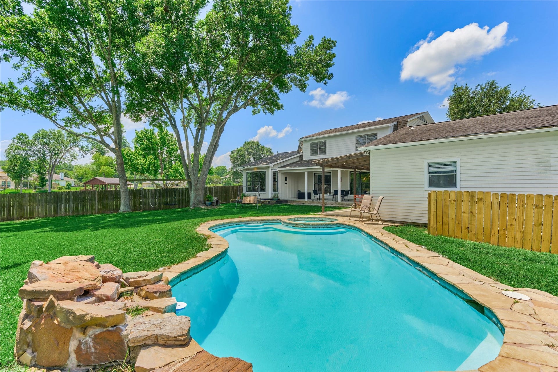 438 Lazy Lane, Montgomery, TX 77356 The backyard oasis is anchored by a sparkling 10,000-gallon pool and relaxing hot tub, inviting year-round enjoyment against a picturesque waterfront backdrop.