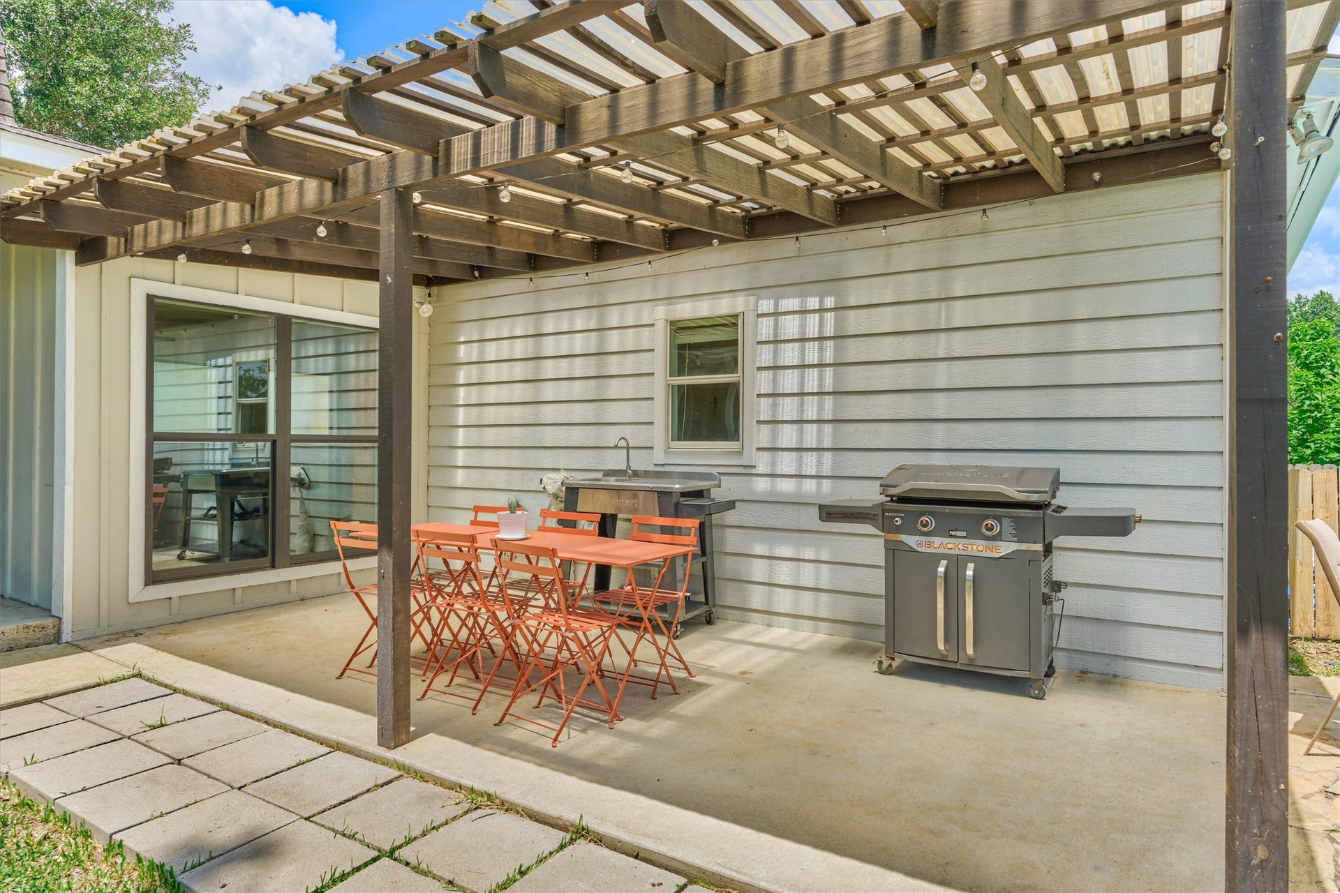 438 Lazy Lane, Montgomery, TX 77356 A pergola- covered gathering space offers a beautful setting next to the pool.