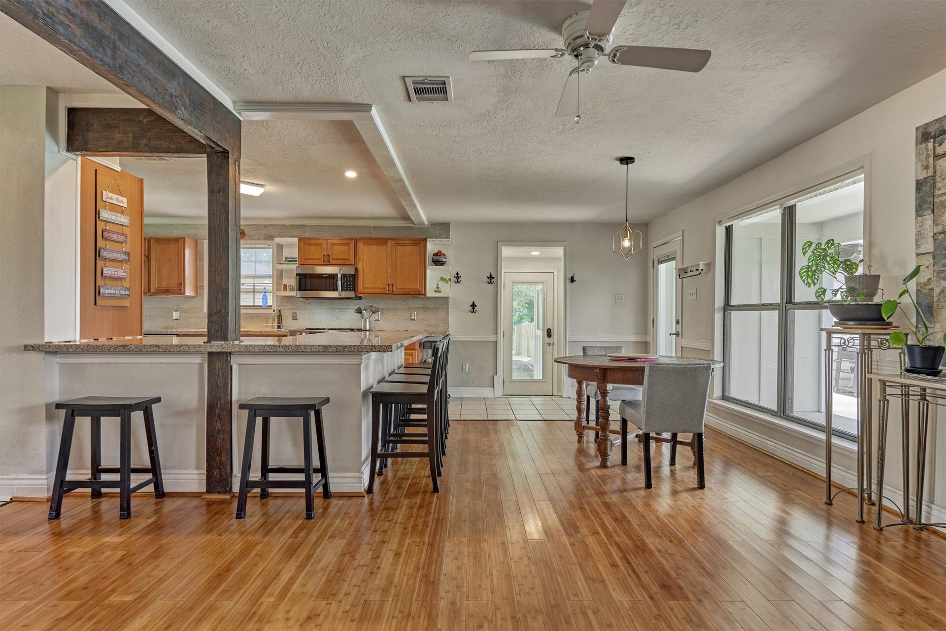 438 Lazy Lane, Montgomery, TX 77356 Designed for comforatble living and effortless entertaining, the oversized breakfast bar offers ample seating while decorative wood beams define the space.