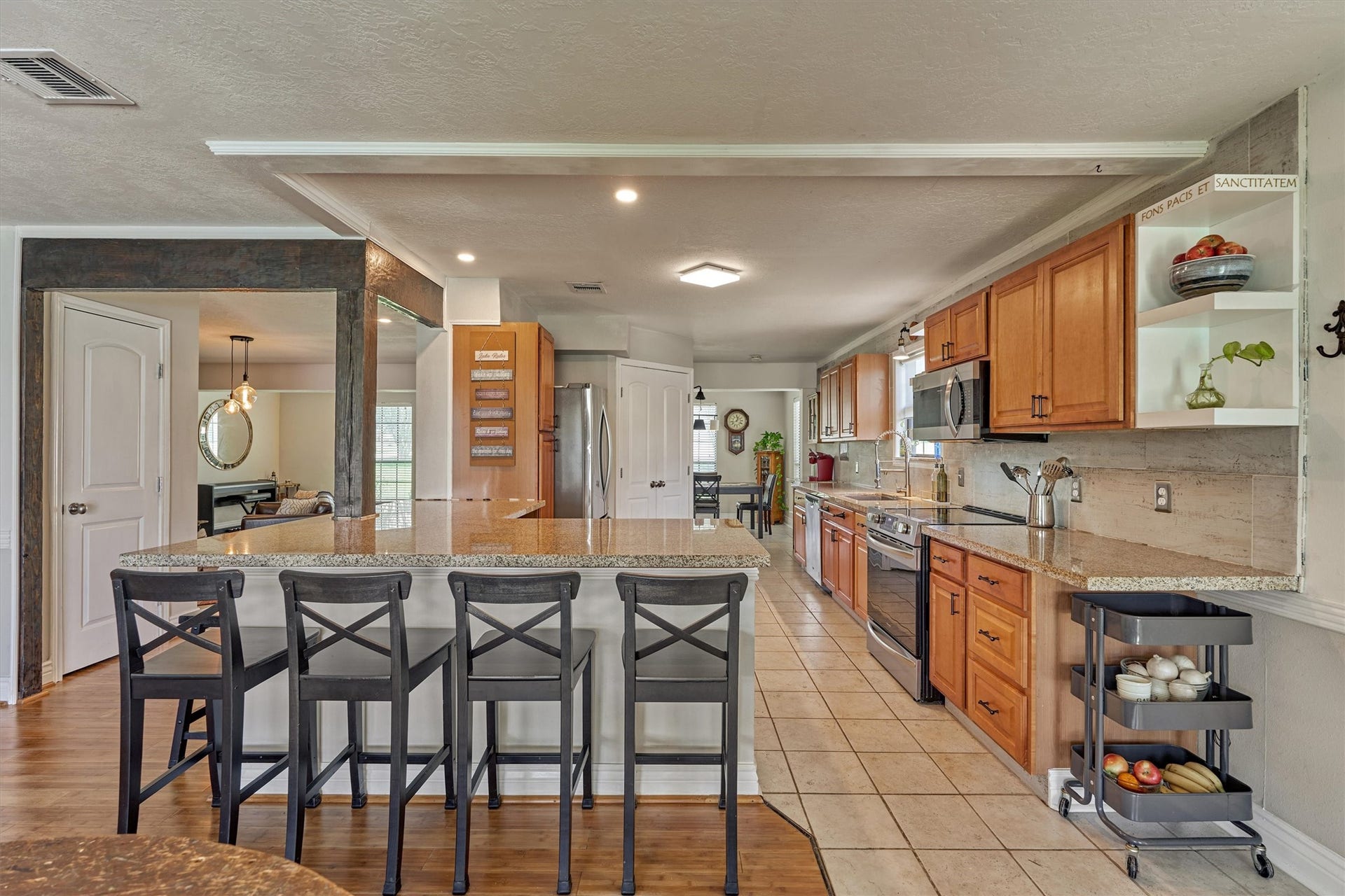 438 Lazy Lane, Montgomery, TX 77356 Tile flooring flows throughout the kitchen, while the open display shelving adds charm and functionality.