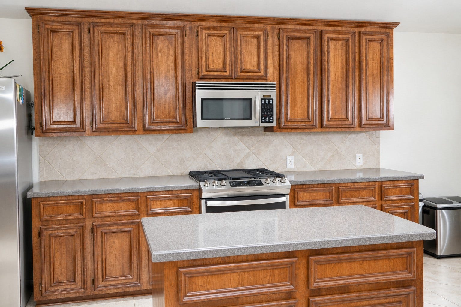 Kitchen cabinets showing the stove and microwave.