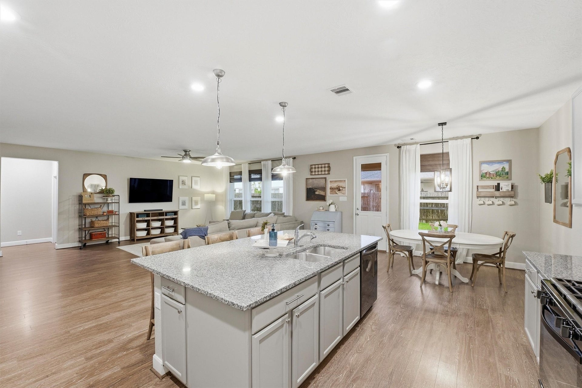 3502 Saxton Green Rd Road, Pearland, TX 77584 Looking out into the living area and dining area from the kitchen- think of all of the family and friends that could fit in here!