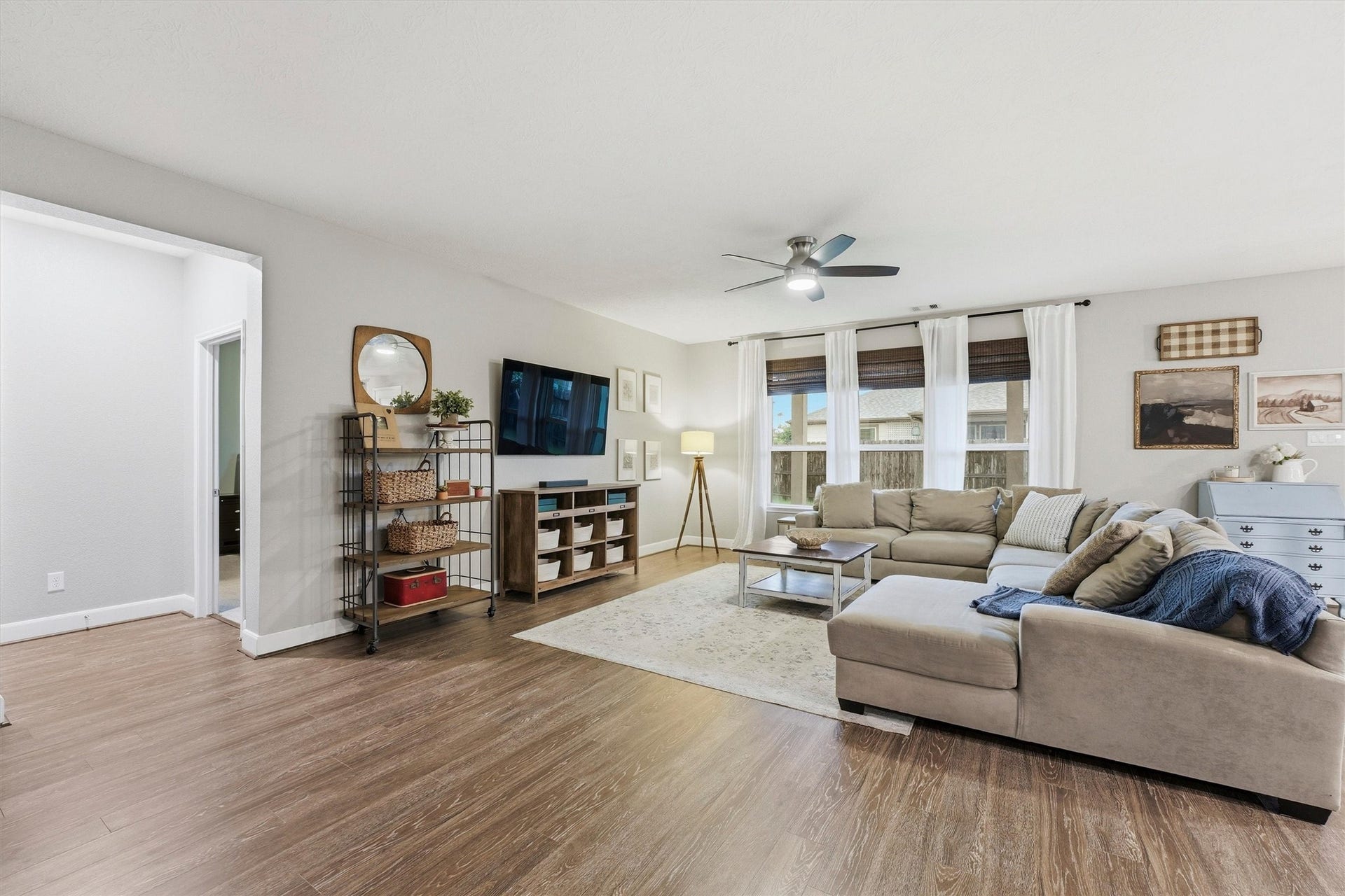 3502 Saxton Green Rd Road, Pearland, TX 77584 This spacious living room features abundant natural light, wood-look LVP flooring, and an open concept layout perfect for entertaining.