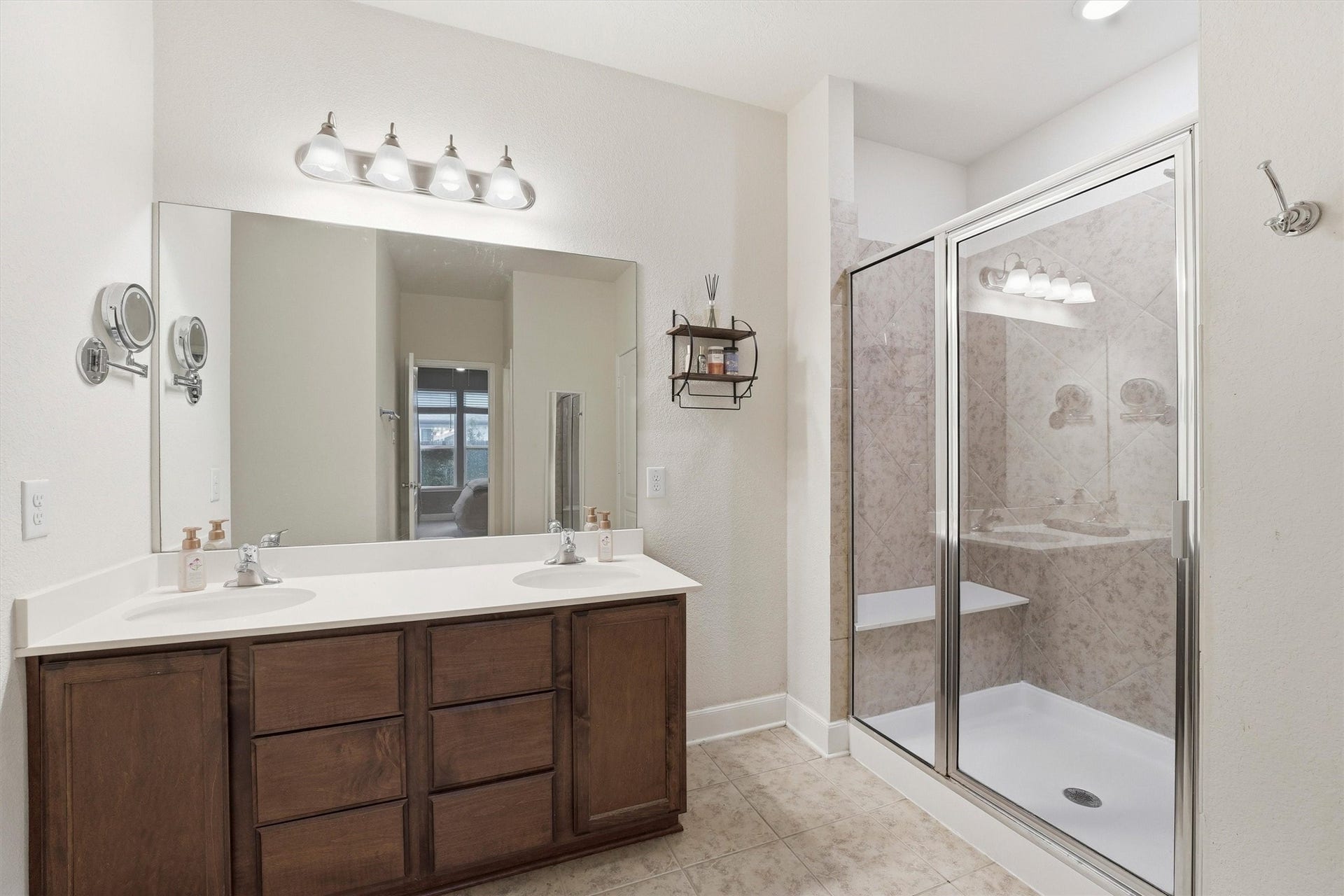 3502 Saxton Green Rd Road, Pearland, TX 77584 Well-designed primary bath with separate vanities, generous storage and a walk-in shower with tile surround.