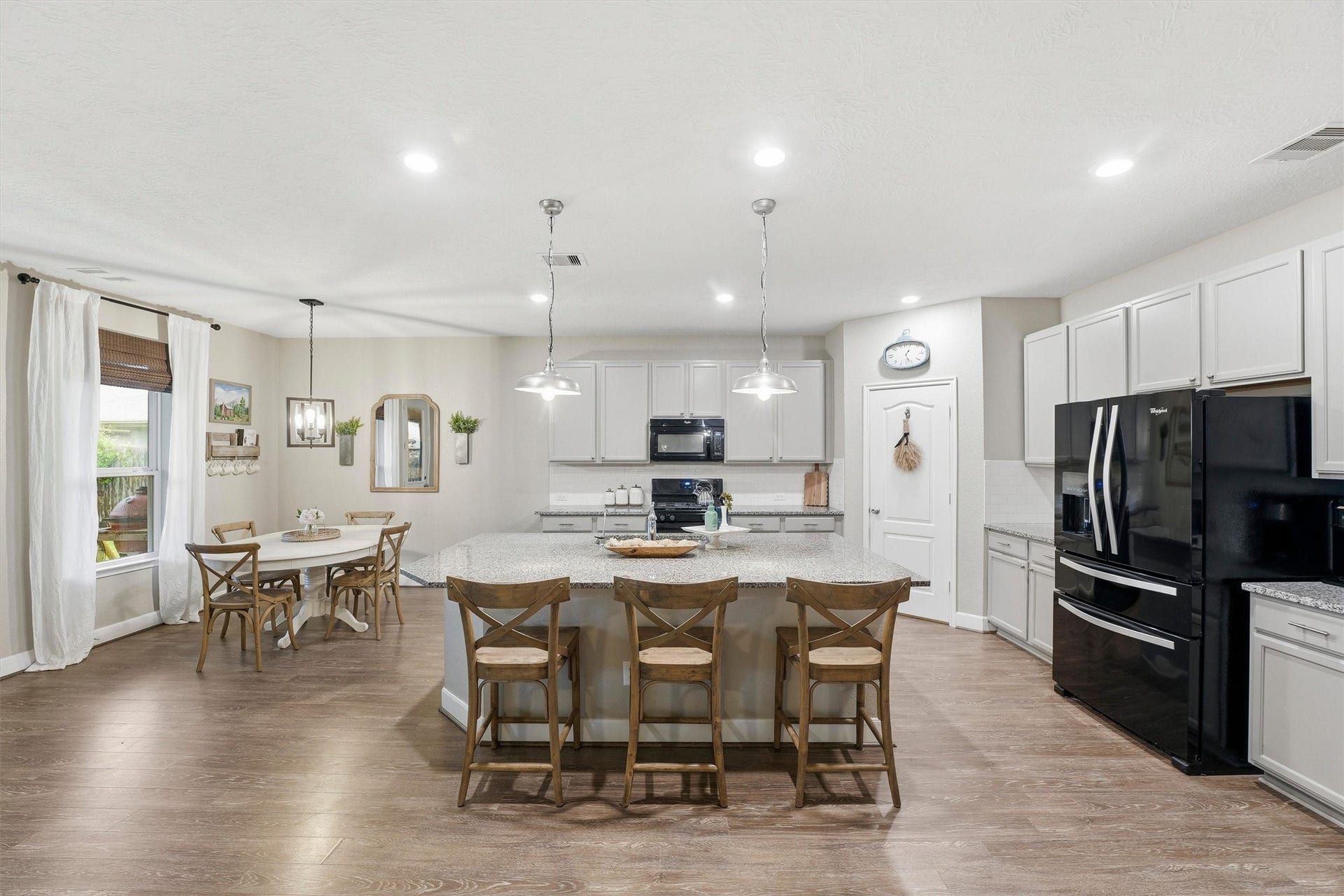 3502 Saxton Green Rd Road, Pearland, TX 77584 Large kitchen with spacious center island (truly- it's huge!) with bar seating, abundant cabinetry, and an adjacent dining area.