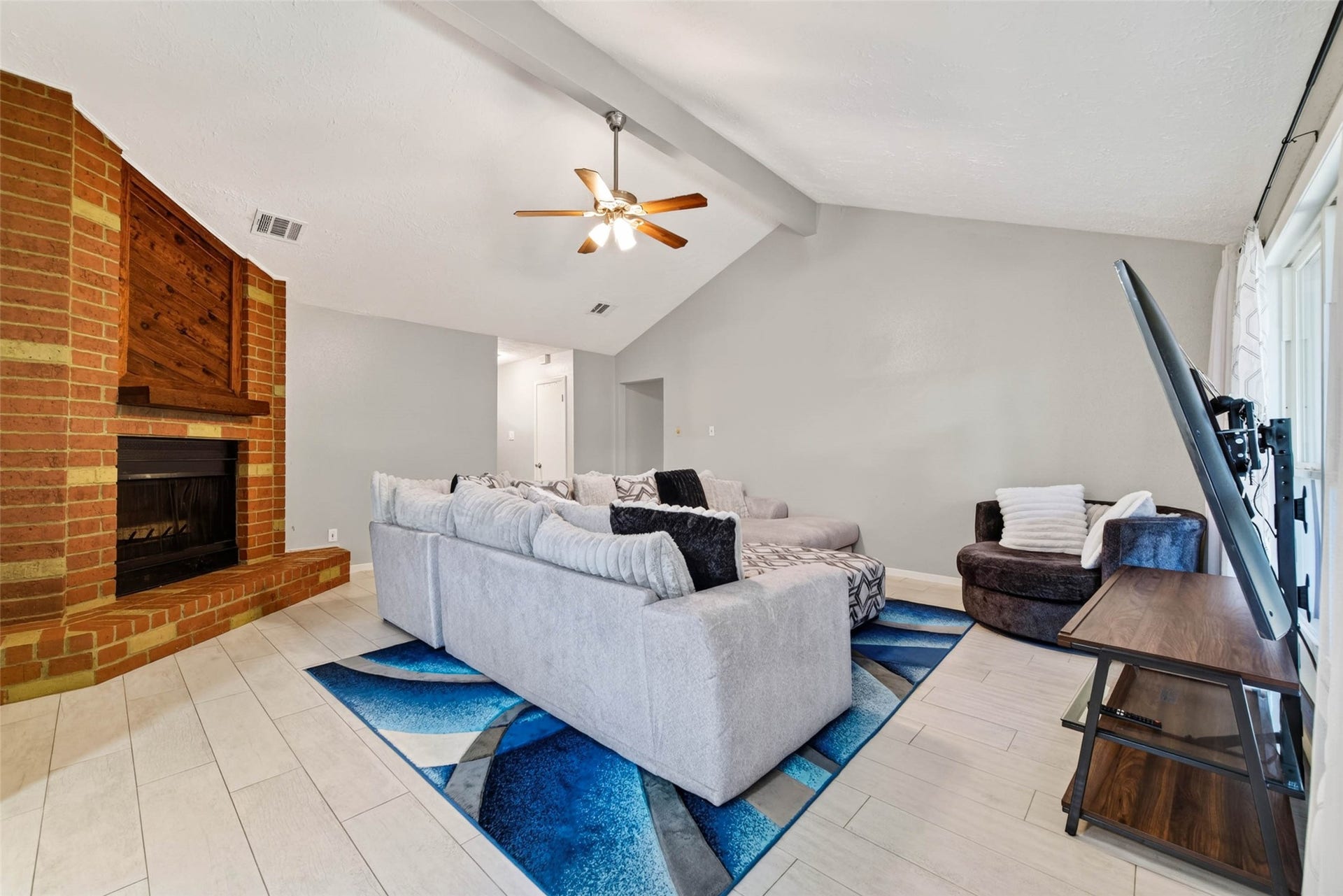 The living room has high ceilings and a nice fireplace to bring the family together.