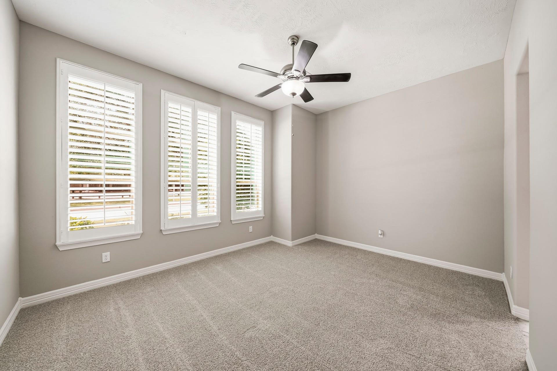 Front of house Secondary bedroom with fan, plantation shutters and connected to Hollywood/JackandJill bath.