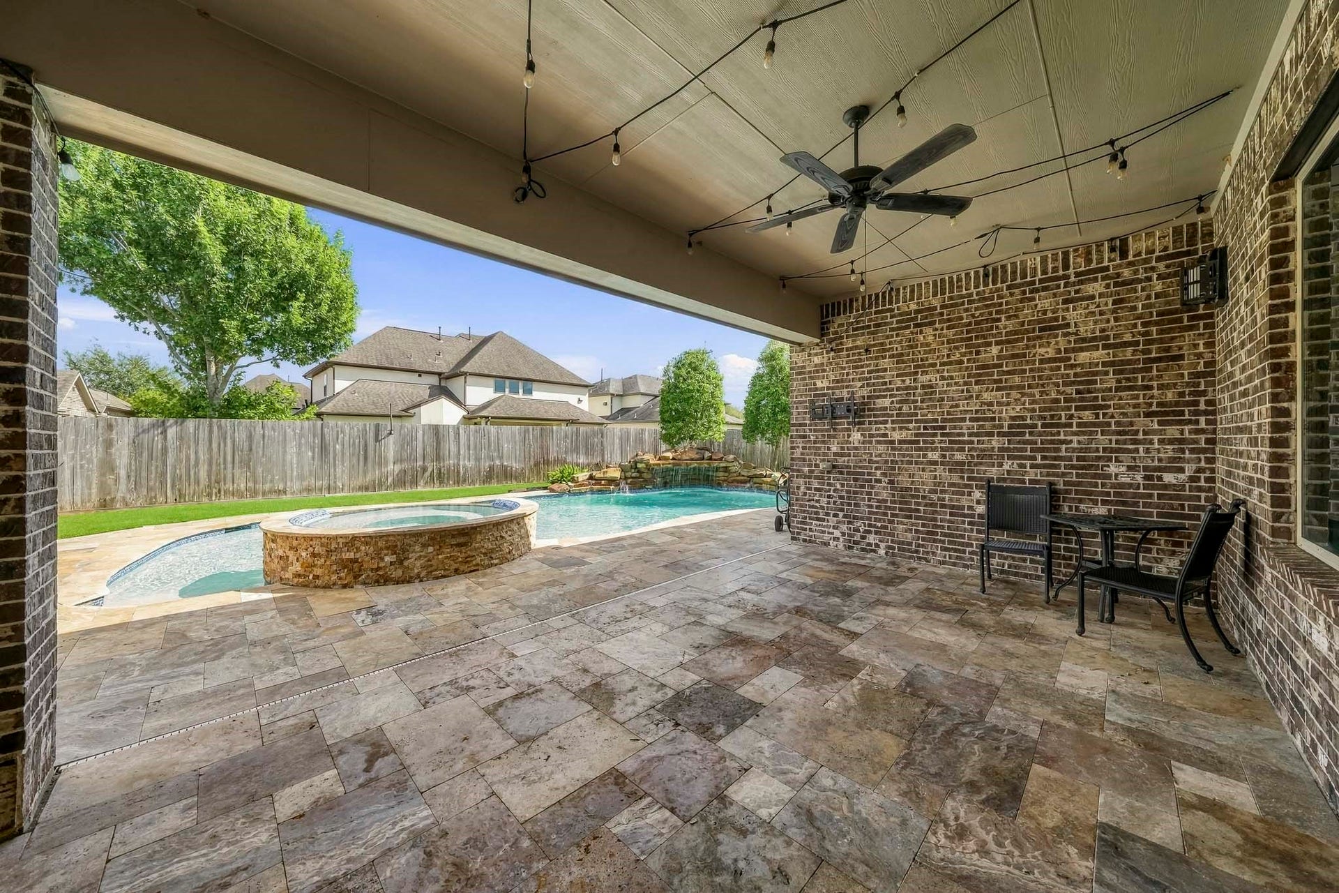 Beautiful travertine stone. Large, covered patio, gas nub for grilling, TV mount to stay.